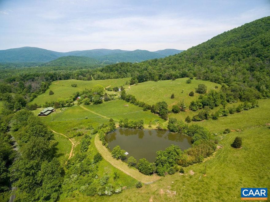 SPRING HILL   Beautiful 207+ acre farm in a protected enclave of Madison County with incredible views of both the Blue Ridge and Southwest Mountains.  The natural beauty and privacy are unparalleled.   An attractive farmhouse with a c. 1804 section could be updated for a main residence, weekend getaway or guesthouse if a buyer want to take advantage of numerous incredible building sites.  Additional improvements include a large pond with dock center aisle stable with 8, 12 x 12 stalls and finished office space above, manager?s cottage, garage, farm buildings and good farm infrastructure  An excellent candidate for conservation easement.,Formica Counter,White Cabinets,Wood Cabinets,Fireplace in Kitchen,Fireplace in Living Room,Fireplace in Study/Library