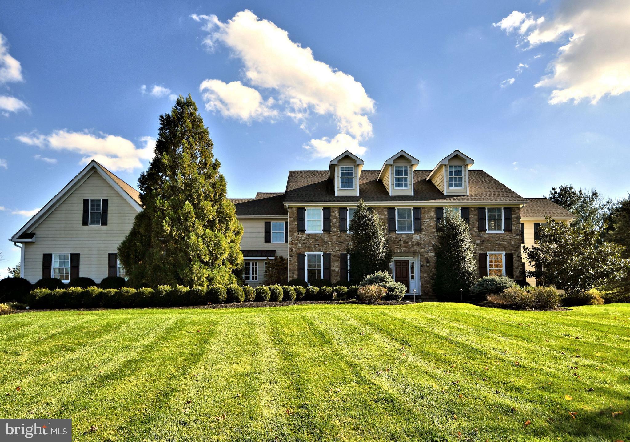 An extraordinary example of design, elegance, attention to detail and meticulous craftsmanship. Situated on a gorgeous 3 acre lot with high elevations and stunning views of Upper Makefield's very own Jericho Mountain! This magnificent estate was built with stone and "Hardy-plank" exterior and was designed with both traditional and modern amenities. Bluestone walkways and manicured flower beds lead you to the front mahogany door and into the grand foyer with open staircase and gleaming oak hardwood flooring throughout two levels of the home. An executive formal Study is quietly tucked to the right and formal dining room fitted with French doors w/transom window to the left. The gourmet eat-in kitchen with center island lies at the center rear of the home and is fitted with granite counters, professional exhaust hood and premium appliances including the "Wolf Range", "Subzero" refrigerator, refrigerated drawers, 'KitchenAid" dishwashers, custom cabinetry and millwork including slide-out spice and knife drawers. An adjoining breakfast room with built-in workstation egresses via french doors to the outside and rear of the home designed with maintenance free deck and fire-pit. A stunning two-story family/great room featuring coffered ceilings, a marble surround wood burning fireplace, wood trimmed columns and abundant natural lighting all open to the kitchen and outside. The formal living room complete with gas fireplace, pillared columns, exterior French doors, full bath and butlers pantry/wine room opens to the Florida room/Conservatory and provides a perfect venue for entertaining. An additional powder room, mud room, rear staircase, garage access (oversized, heated 3-bay, two of the bays are lift capable with one being lift ready), convenient second basement staircase to the side entrance with covered porch complete the first level. A beautiful oak staircase and spacious landing divides the 2nd floor and provides third level access. A graciously appointed master suite includes a gas fireplace, tray ceilings and walk-in closet with custom built-ins. The luxurious master bathroom was completed with double sink vanity, whirlpool tub, roman shower along with a private commode. Bedrooms two, three and four are all ensuite with their own private bathrooms. A hall laundry, rear staircase, and second floor living room opens to the fifth bedroom-au pair suite with its own sitting room. The third level includes additional living space with two spacious entertainment rooms. The basement has both front and rear staircase and provides housing for the furnace, air handlers, hot water heaters, "HAI" home management system, electrical panels, protective whole-house generator panel, New well pump and New 'LED' lighting. -Outside living was designed with an extended rear deck and patios complete with granite countertops, fire magic echelon grill with side burners, wet bar, built-in blender, sub zero outdoor refrigerator, as well as a flat screen TV mount and wiring. Professionally landscaped with beautiful long distance views, and privacy. A truly special place to call home!