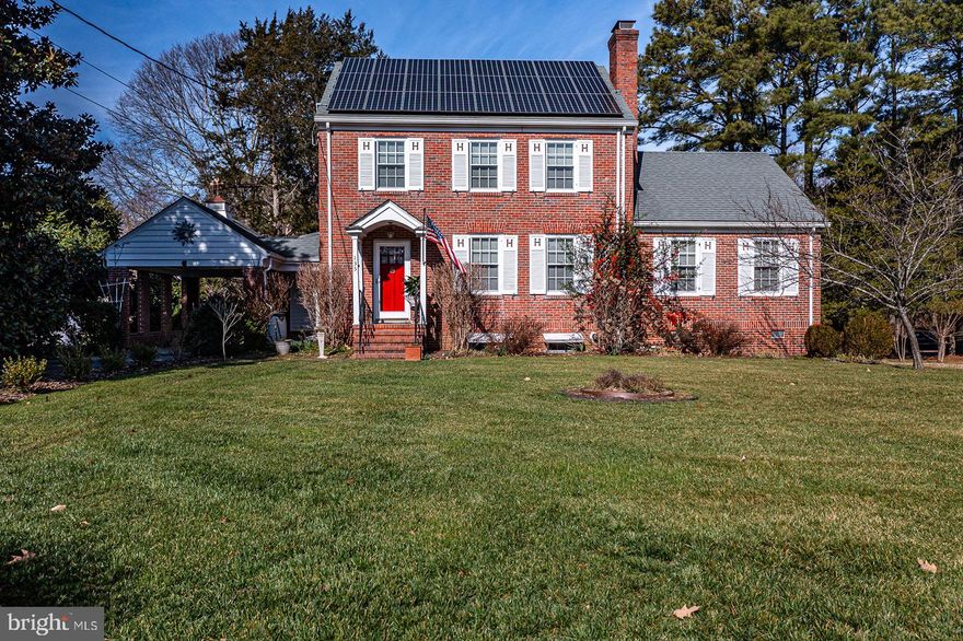 Fabulous living in the Town of Kilmarnock! This all Brick home on  .675 AC offers hardwood floors, a remodeled kitchen, carport plus two car detached garage, & hot tub on the LARGE back covered Porch w/Azek decking. The Foyer is a beautiful entrance leading to the Living Room with a gas log Fireplace. Upper floor staircase off entry adds charm. Double glass doors open to the formal Dining Room w/pellet stove. The Kitchen has been updated with quartz countertops, gas range, Double ovens, wine cooler, oversized windows providing great natural light, a utility/laundry room to the side, and a cozy Breakfast nook adjacent to the rear Porch. The Primary Suite is on the Main floor with UPDATED Bathroom done in 2020. Upstairs offers 3 bedrooms with a full hall bathroom. Bath has a door for access to stairs for the attic; space is floored with unfinished hardwood. The Basement has two rooms currently used for storage, workshop, & mechanicals; both are heated and cooled. Instant Hot Water heater. 20KW Generator. Solar panels plus GEO-THERMAL  heat and cooling provide great comfort and low utilities! Property is spacious with a rear garden and  driveway access to both E. Church St and Town Center Drive. Local Shops, Library, and Restaurants close-by; as well as Super Markets, Walmart, YMCA, & Bon Secours Hospital. Don’t miss your opportunity to live in this charming home in the Town Of Kilmarnock.