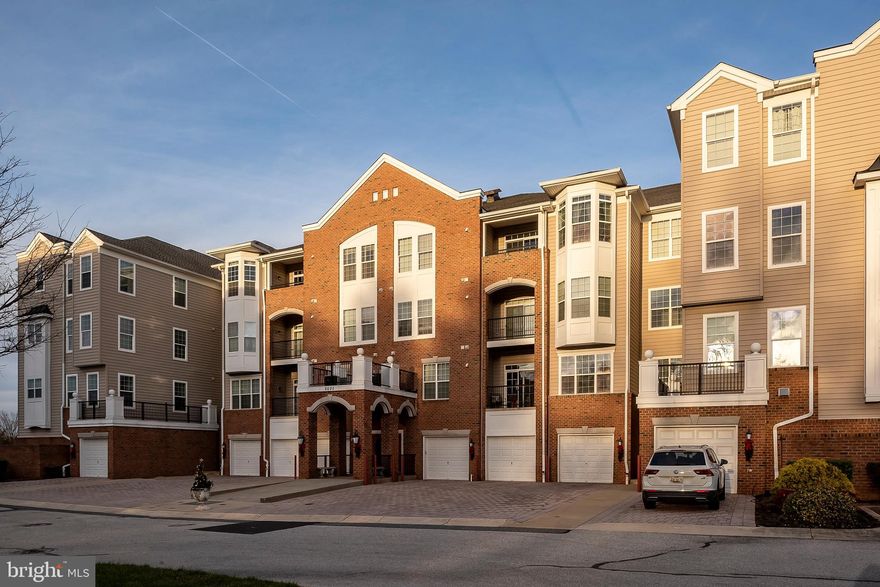 You are going to love the secure oasis that Cedar Ridge/Piney Orchard offers. The elegant amenity-rich 55+  active adult community welcomes you into your own private retreat! Parking is never an issue as you have your own garage plus assigned parking. The garage is conveniently located in the same building.  Plenty of visitor parking when you entertain. The conveniences offered here include tennis courts, swimming pool, jogging and walking paths, fitness center, club house, and so much more. Step inside the secured building with elevator access and a welcoming foyer/sitting area. Meticulously maintained! Lovely territorial views from penthouse level.  This amazing home boasts 2 large bedrooms, 2 commodious bathrooms,  a grand foyer, 9' ceilings, coffered ceilings and handsome moldings. Spacious gourmet- inspired kitchen has all you want! Built-in microwave, 42" cabinetry, bright sunny windows, lots of prep space - even a built in desk area for organizing! The kitchen has an oversized breakfast nook that could be a family room, if desired.  Enjoy formal settings in the dining room boasting a decorative fireplace. The living room is complemented with formal columns and an attached den. The grand master suite is fantastic! Plenty of space, large walk-in closet plus a second closet, and a generous private, master bath that has a walk-in shower with bench and beautiful glass doors, plus a large double vanity.   Large second bedroom just steps away from a second full bathroom.  You'll appreciate having a laundry room including a washer and dryer right in the unit.  This is truly one of the most spacious, loveliest units in Piney Orchard.