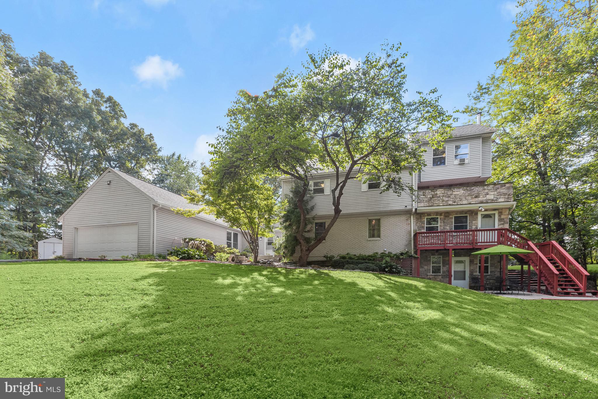 A unique and beautiful property awaits in the Woodbine community of Howard County! Possibilities abound in this multi-generational, potential income-generating colonial-style home with four separate levels of private living. Arrive into the main level and experience an open-concept living, dining, and kitchen area with the living room featuring a cathedral ceiling with wood beam accents, a wood-burning fireplace with a rich stone surround, and gorgeous hardwood floors that continue throughout. Let the gourmet kitchen boast a massive island with a breakfast bar, stainless steel appliances, a sizable walk-in pantry, and is adjacent to the dining room. Relax and unwind in the primary bedroom suite and sitting area highlighted by two ensuites, one with a ceramic tile walk-in shower, and a walk-in shower. An additional bedroom and bath complete the main-level living quarters. The second-floor unit provides three bedrooms, a primary bedroom suite, custom blinds, and access to a private balcony. The penthouse level, third unit provides an open-concept floor plan with three bedrooms, a full bath, and laundry ideal for hosting guests. A fully finished lower level offers a full fitness room, a living room, two bedrooms, two baths, and a full kitchen with its own entrance. Take part in the great outdoors and host any special occasion with an in-ground pool, patio, and hot tub. Major commuter routes include US-40, MD-32, and I-70 for easy travel to Columbia Mall and Merriweather Post Pavilion.