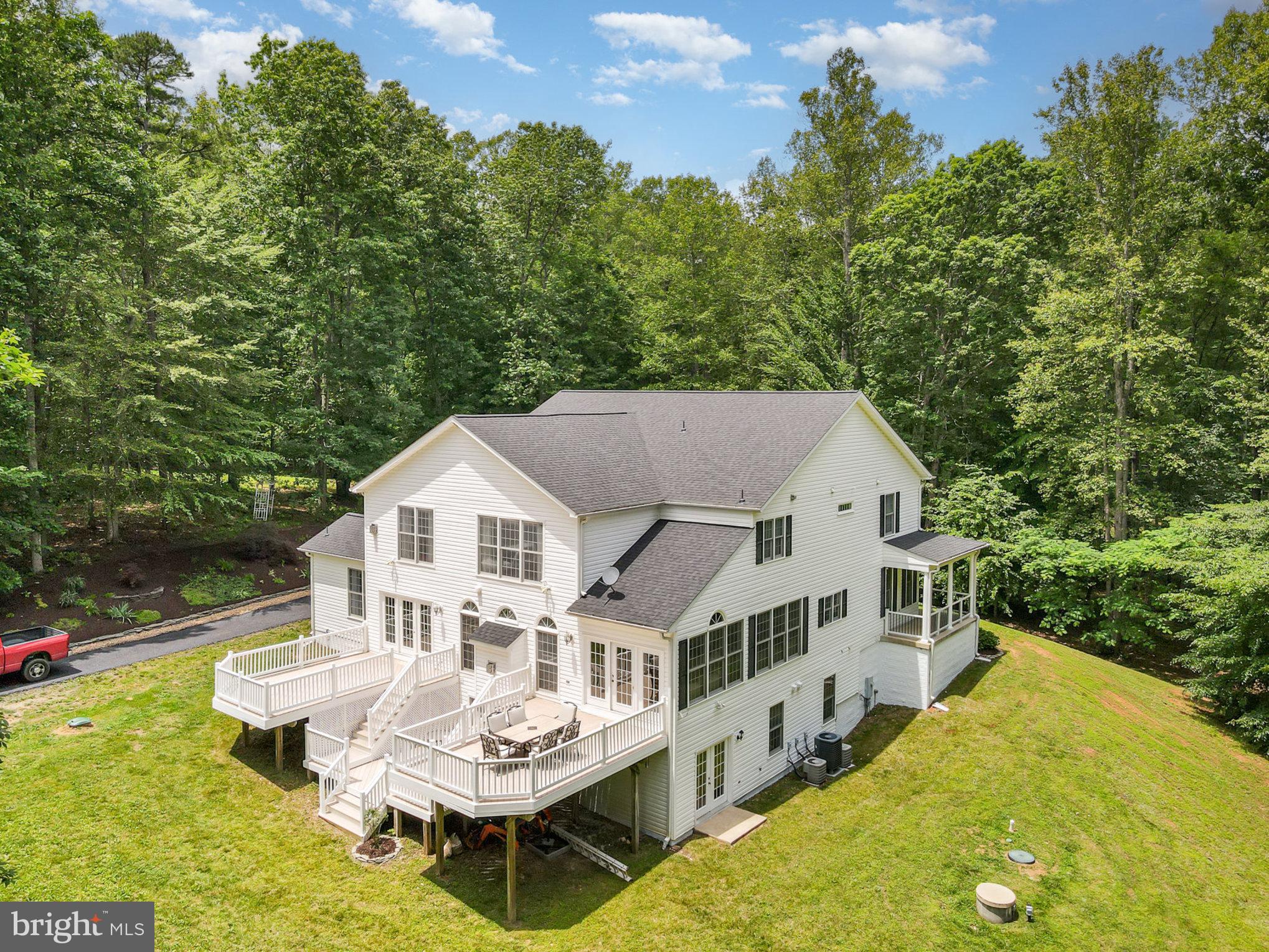 Your private & peaceful retreat nestled on 11.4 acres of pristine land is waiting for you! This spacious and updated home offers the perfect blend of modern comfort and timeless country charm. Step onto the expansive, country-style front porch, ideal for enjoying your morning coffee with serene views. Inside, the open entryway welcomes you with a grand staircase and gleaming hardwood floors throughout the main level. The heart of the home—your updated kitchen—features brand-new quartz countertops, custom tile backsplash, and an eat-in dining nook surrounded by large, sun-drenched windows. Unwind in the cozy living room with a gas fireplace, arched windows, and elegant columns, or entertain guests across the formal living and dining rooms—each with atrium doors that open to the front or back porch. The main level also includes a bedroom with full bath, perfect for guests or multigenerational living, plus a dedicated home office. Enjoy summer gatherings on the 3-tier deck overlooking your fenced-in backyard. Upstairs, you'll find 5 generously sized bedrooms with brand-new carpet, a spacious loft, and a luxurious primary suite with a fireplace, spa-like bathroom, and dual walk-in closets. The fully finished walk-out basement offers even more versatility, complete with a full bath, flexible living areas, and ample storage. Car enthusiasts and hobbyists will love the 48’x40’ detached garage/workshop with a car lift, plus a 2-car attached garage. A new roof (2024) adds peace of mind. Just under an hour from Washington, D.C. Don’t miss your chance to own this haven!
Don’t miss your chance to own this haven!