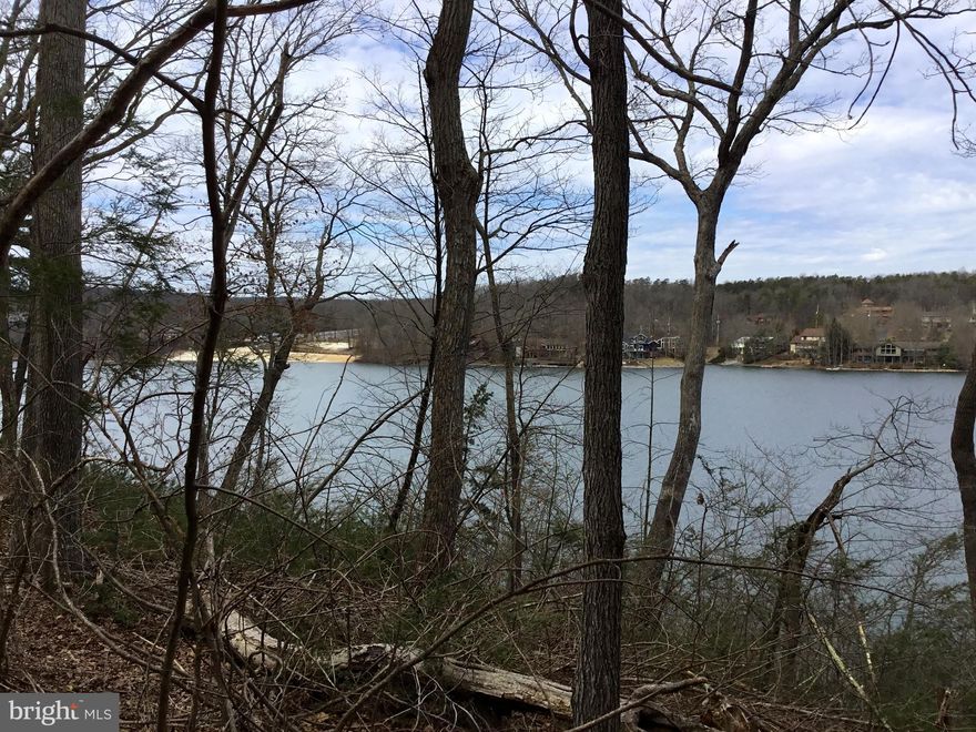 Waterfront recreational lot on 240 acre lake. Allows access to all Lake Holiday amenities.  Enjoy the lake - swimming, fishing, boating, water ski, kayak or canoe!  Boat slips are offered at the marina.  Have a picnic and lay on the beach.  But wait!  There's more!  Clubhouse, exercise room, basketball, tennis, and volleyball courts, tot lot, and hiking trails. Less than two hours from the beltway!  Great weekend getaway. No capitalization fee required.