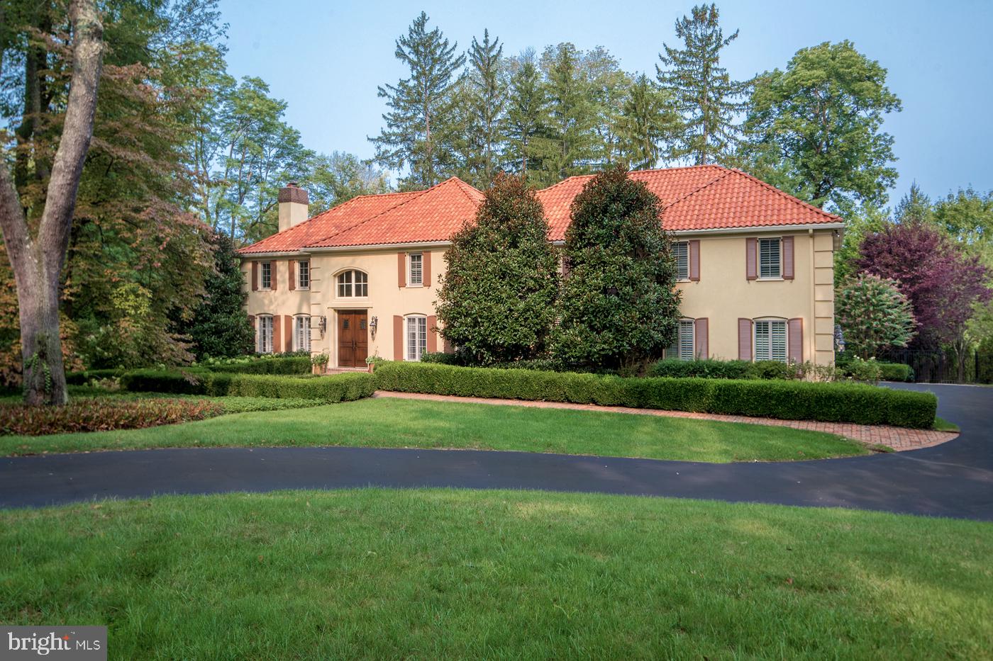 Built for family living and entertaining, this grand 6 bedroom, 5.1 bath estate nestled on a lush 1.43-acre cul-de-sac lot has all you could possibly dream of – from gorgeous grounds and interiors to a low-maintenance exterior, plus heated resort-style pool and spa for the best stay-cations! Topping the appeal is the private setting and coveted “walk-to-Wayne” address, in a wonderful neighborhood convenient to schools and amenities. The beautifully renovated and expanded residence is inviting and sun-filled, with an elegant center hall and effortless flow between generously-sized rooms. Be dazzled upon entry by high airy ceilings, large windows with picturesque views, exquisite millwork and moldings, rich oak floors and refined finishes gracing the ambience. Relax with guests around the gas fireplace in the large living room and enjoy dinner parties and holidays in the formal dining room. Hosting a crowd is seamless with a nearby butler’s pantry, and fabulous open floorplan connecting the expansive gourmet kitchen, breakfast room, family room, and rear terraces for the best indoor-outdoor gatherings! Custom cherry cabinets with oiled bronze hardware, granite countertops, an oversized prep/eat-in island, antique French tiled floor and backsplash, and premium appliances by Thermador, Miele and Sub-Zero offer an inspired culinary experience. By the living room is a serene library for working or reading, with French doors leading to the outdoor terraces and pool oasis. Many other highlights will impress you just as much and make you love being at home. Upstairs you’ll find the luxurious master suite with custom his & her walk-in closets/dressing rooms and spa bath, 5 more spacious bedrooms (one currently used as a study) with 3 custom tiled designer baths and a laundry room. The enormous finished day-lit walkout lower level featuring something for everyone. Here you’ll find an incredible recreation/game room, media/movie room for watching flicks, sunny gym for staying fit, and wine cellar for favorite vintages, along with a second laundry room and full bath with easy access to the pool. There’s also lots of built-in storage, whole house/pool WiFi and whole house streaming music controlled by mobile devices, and a fenced yard area for the dogs. Not to mention a great location near top schools, restaurants, shopping, the post office, regional trains, the airport and Center City.