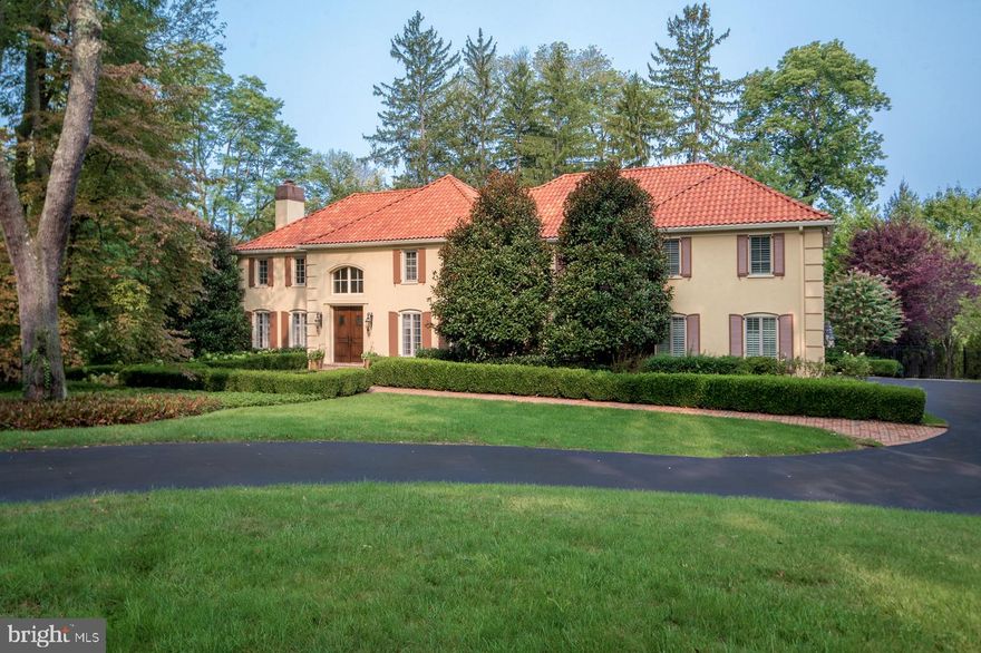 Built for family living and entertaining, this grand 6 bedroom, 5.1 bath estate nestled on a lush 1.43-acre cul-de-sac lot has all you could possibly dream of – from gorgeous grounds and interiors to a low-maintenance exterior, plus heated resort-style pool and spa for the best stay-cations! Topping the appeal is the private setting and coveted “walk-to-Wayne” address, in a wonderful neighborhood convenient to schools and amenities.  The beautifully renovated and expanded residence is inviting and sun-filled, with an elegant center hall and effortless flow between generously-sized rooms. Be dazzled upon entry by high airy ceilings, large windows with picturesque views, exquisite millwork and moldings, rich oak floors and refined finishes gracing the ambience. Relax with guests around the gas fireplace in the large living room and enjoy dinner parties and holidays in the formal dining room. Hosting a crowd is seamless with a nearby butler’s pantry, and fabulous open floorplan connecting the expansive gourmet kitchen, breakfast room, family room, and rear terraces for the best indoor-outdoor gatherings! Custom cherry cabinets with oiled bronze hardware, granite countertops, an oversized prep/eat-in island, antique French tiled floor and backsplash, and premium appliances by Thermador, Miele and Sub-Zero offer an inspired culinary experience. By the living room is a serene library for working or reading, with French doors leading to the outdoor terraces and pool oasis. Many other highlights will impress you just as much and make you love being at home. Upstairs you’ll find the luxurious master suite with custom his & her walk-in closets/dressing rooms and spa bath, 5 more spacious bedrooms (one currently used as a study) with 3 custom tiled designer baths and a laundry room. The enormous finished day-lit walkout lower level featuring something for everyone. Here you’ll find an incredible recreation/game room, media/movie room for watching flicks, sunny gym for staying fit, and wine cellar for favorite vintages, along with a second laundry room and full bath with easy access to the pool. There’s also lots of built-in storage, whole house/pool WiFi and whole house streaming music controlled by mobile devices, and a fenced yard area for the dogs. Not to mention a great location near top schools, restaurants, shopping, the post office, regional trains, the airport and Center City.