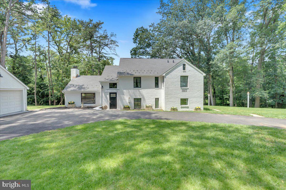 A Rare Retreat on 2.4 Acres in the Heart of Swarthmore
Nestled at the end of a quiet lane and surrounded by nature, this beautifully reimagined home sits on 2.4 private acres—a rare offering in Swarthmore. Comprised of three combined lots, the property offers endless possibilities for gardening, outdoor entertaining, or simply enjoying the serenity of your own wooded oasis.
No detail was overlooked in the complete renovation of this home. From the new circle drive leading into the property, the brand-new roof, electrical, and plumbing systems to the energy-efficient geothermal heating, everything has been thoughtfully upgraded. Natural light pours in through Pella windows, highlighting the quality craftsmanship and modern finishes throughout.
The first floor consists of a gorgeous living room with the fireplace as its centerpiece flanked by built-in bookshelves. The formal dining room overlooks the rear yard. Off the kitchen is a fantastic mudroom, pantry and powder room. Lastly, the office/den is the perfect sanctuary to spend your time indoors. On the second floor are three bedrooms all with ensuite bathrooms. The primary has a walk-in closet and a large bathroom with a stunning soaking tub, double sinks and glass enclosed shower. The hall laundry is convenient for all the rooms. Before heading upstairs is a landing that overlooks the living room. It’s a great space for an office or hangout area. The third floor bedroom area is large enough for two beds and a lounge area. The full bathroom is complete with a second laundry area. This space is ideal for an au pair, in-law or office/guest space.
Whether you're sipping coffee on the deck overlooking the trees or cozying up indoors, you'll feel a deep connection to the surrounding landscape. This home is a perfect blend of privacy, sustainability, and modern living—all just minutes from the heart of Swarthmore and its charming downtown, college campus, and train station.
Even though this home is tucked away, you are super close to the Philadelphia Airport and the Regional Rail that takes you into Center City Philadelphia.
A home like this doesn’t come along often. Experience the peace and potential of 1115 Muhlenberg for yourself.