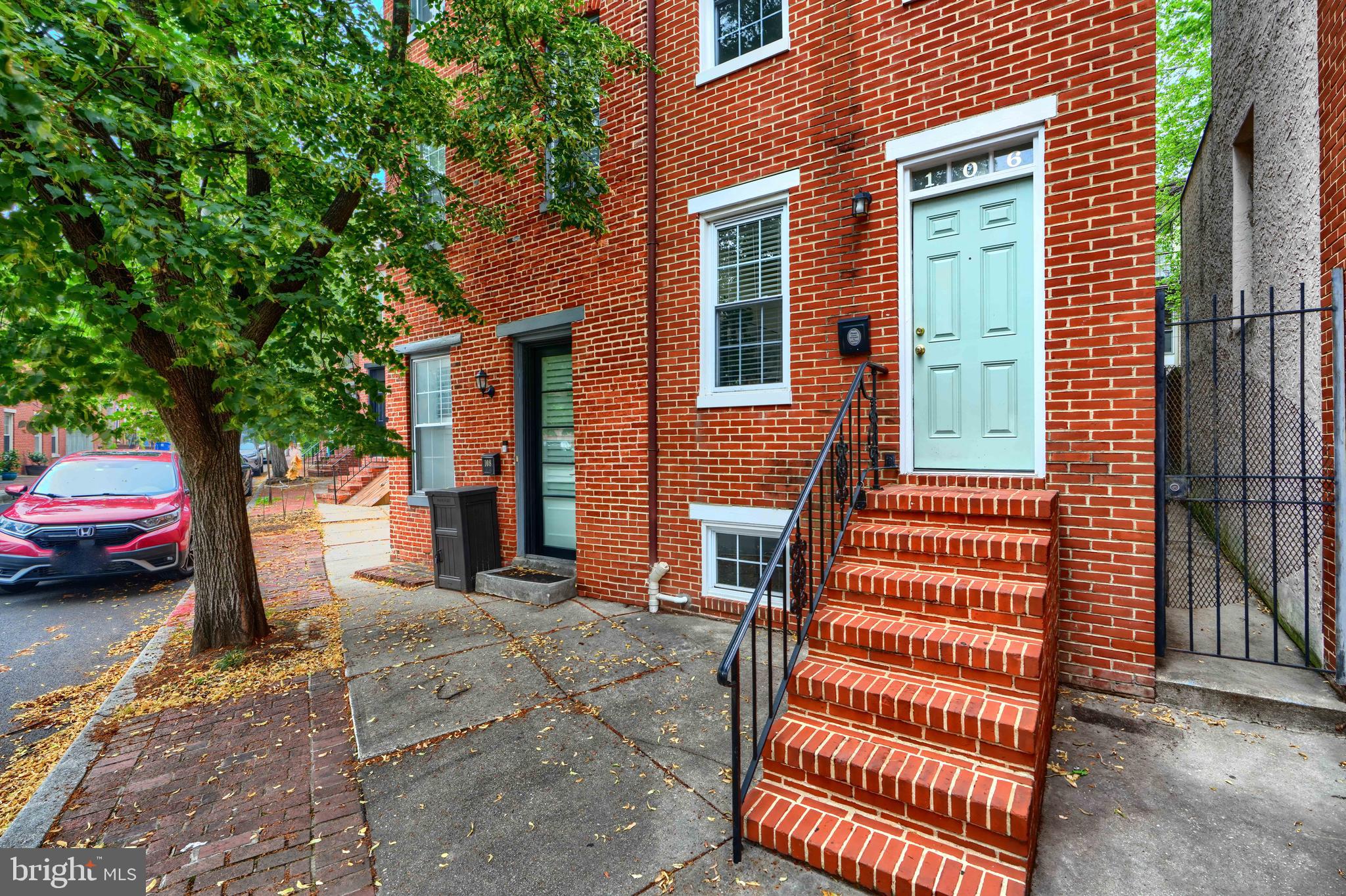 Tucked away on a picturesque, tree-lined street in the heart of historic Otterbein, this delightful townhouse invites you in with its warmth and character. From the moment you step inside, you’ll be captivated by the sunlit living spaces, original light wood floors, and timeless details that make this home feel truly special. The welcoming living room is a cozy retreat, while the separate dining room—ideal for hosting family dinners or festive gatherings—offers the perfect backdrop for creating lasting memories. The updated kitchen is thoughtfully designed, blending modern convenience with classic style, making meal prep a joy.
Upstairs, the second-floor bedrooms are both generously sized, filled with natural light, and perfect for restful retreats or creative spaces. One bedroom even opens to a private balcony, offering a charming spot to enjoy your morning coffee or an evening breeze. The entire third floor is a serene primary suite, complete with its own full bath and a flexible nook perfect for a home office, reading corner, or quiet retreat.
Out back, the private courtyard is brimming with charm and possibility—imagine a lush container garden, twinkling café lights, or cozy evenings under the stars.
Just a short stroll from the Inner Harbor, stadiums, and MARC train station, and surrounded by Otterbein’s historic beauty and tight-knit community, this is city living at its most enchanting.