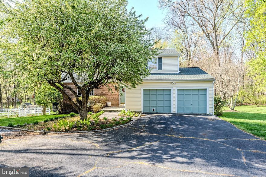 This one-of-a-kind home features a full addition on the lower level with a ground-level entrance, a bedroom/second kitchen, a sitting area, a full bath, laundry, and a private entrance! Perfect for multi-generational living, a home office, a business, or an income property. This beautifully remodeled home, situated on a private lot, offers 4 bedrooms and 3.5 bathrooms with almost 3,500 finished square feet of living space across three levels. The 0.66-acre lot provides privacy and backs to protected woodlands with mature trees. The exterior boasts a newly installed architectural-style shingle roof, a two-car front-loading garage, and an additional paved driveway for extra parking. The main level features fresh, neutral paint and well-maintained hardwood floors throughout, with an open floor plan. The foyer leads to a half bath and coat closet, followed by a bright and airy formal living room and a dining room with windows overlooking the backyard and mature trees. The remodeled kitchen includes an eat-in area, custom 42” raised panel wood cabinets, gleaming granite countertops and backsplashes, updated fixtures, and recessed lighting, and newer stainless steel appliances including a smooth top range with double ovens. The bar area is perfect for casual dining and entertaining, seamlessly connecting to the light-filled family room and a multi-level composite rear deck featuring a covered area with a lighted ceiling fan overlooking the private yard with a shed and fenced garden with woodlands beyond. The upper level offers four bedrooms, two full bathrooms, and ample closet space. The spacious primary suite boasts hardwood flooring, a walk-in closet with custom organizers, a separate dressing vanity, and ensuite bath. Down the hall three generously sized bedrooms, each with hardwood flooring, provide comfort and style. The beautifully remodeled full hall bath includes a comfort-height white vanity topped in granite with a vessel sink, custom tile, brushed nickel fixtures, and more. The fully finished lower level offers a large recreation room, a huge laundry room with cabinets and folding counter and front loading washer and dryer and ample storage. The expansive addition at the rear of the house features a ground-level entry and full walkout. The large rec room leads to the addition/sunroom with walls of windows and skylights, which connects to a catering kitchen. This space could function as an in-law suite, home business, or income-producing property. The second sun filled summer kitchen includes a fantastic industrial sized sink, freestanding freezer, table space, and opens to the deck - perfect for indoor and outdoor dining and entertaining! An additional full bathroom, a second washer and dryer, and a private entrance, makes it a flexible space to suit any needs. Recent upgrades include fresh paint throughout, an updated kitchen, newer two-zone HVAC systems, architectural-style roof shingles, two refrigerators, a freestanding freezer, two dishwashers, two sets of washers and dryers, and a large TV in the lower level, which conveys with the home. Ideally located near the W&OD Trail and just minutes from downtown Vienna, Reston Town Center, the Dulles Toll Road, and the Vienna Metro, this home is a commuter’s dream!