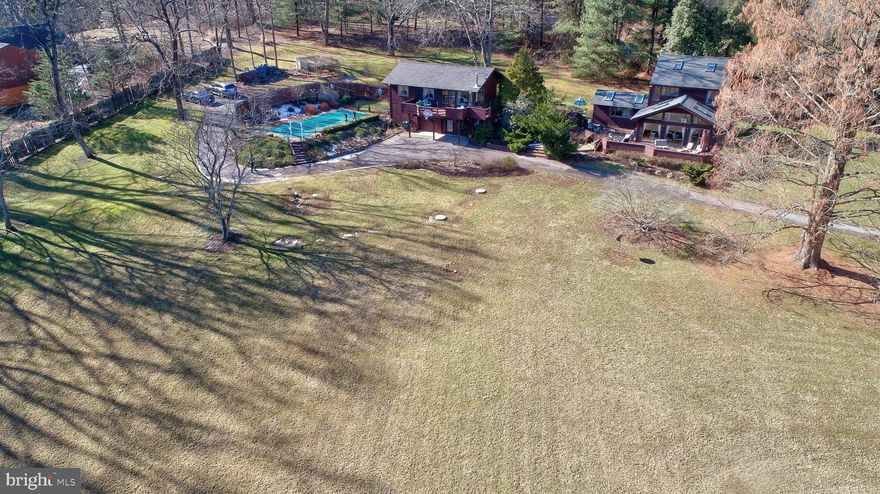 Not your average cookie cutter, this rustic retreat will make you feel like you are on vacation 365 days a year. The main house has 3 bedrooms and two full baths while the separate guest house has an additional 2 bedrooms, one full bath, full kitchen and balcony. Privately located on the Gunpowder River and NCR Trail. Just a short drive to the city for work, art and culture, yet quietly secluded along the river among the sycamore trees and abundant wildlife. Bike along the trail, tube down the river, hike, fish, golf, run or just relax on the deck with a glass of wine and enjoy the magnificent views. Inground pool, extensive hardscaping and landscaping, true zen living.Renovated bath and laundry rooms; New HVAC system, New Roofs on Main and Guest House, New Stain with 10 year guarantee; new pool liner and pump 08/2018; new filtered water and water softener system. Vaulted ceilings, exposed beams, and stacked stone fireplace.