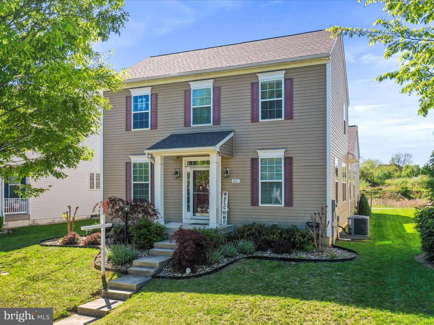 Welcome to this beautifully maintained 4-bedroom, 2.5-bath colonial nestled in the sought-after Lakeland Place! Offering 2,232 square feet of comfortable living space, this home combines modern updates with timeless style—including a brand-new roof installed in 2023. Step inside to an inviting open-concept main level, perfect for everyday living and entertaining. The living room features a cozy gas-stove fireplace, while the eat-in kitchen boasts a blend of granite and butcher-block countertops, an island with seating, a pantry, plenty of cabinetry, and dining area. There’s also a bonus room—ideal as a home office, playroom, or formal dining space. The main-level primary suite offers a peaceful retreat, complete with a walk-in closet and an en suite bath featuring a double vanity, walk-in shower, and linen closet. A handy mudroom with a half bath connects to the rear-facing 2-car garage, which includes built-in shelving and a workbench—perfect for DIY enthusiasts or extra storage. Additional highlights include a full, unfinished basement ready for your personal touch, and a community with sidewalks, street lights, and two playgrounds. Located close to major commuter routes and shopping, this home offers the perfect balance of convenience and comfort. Don't miss your chance to call this home! Schedule your showing today!