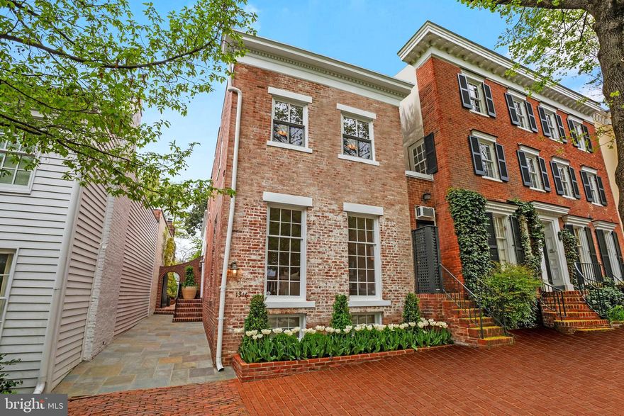 Elegance and West Village charm with rare 2-3 car parking, a side entrance private courtyard, patio, and deep garden! Experience the epitome of Georgetown living in this sun-filled, semi-detached quintessential Georgetown residence with magical yet private Georgetown views. Boasting 4 Bedrooms, 3.5 Bathrooms and over 3,000 square feet of living space across 3 levels, this home exudes timeless elegance and modern luxury. Step inside to discover the high ceilings, original pine wood floors and impeccably proportioned rooms that bathe in natural light. The main level welcomes you with an elegant living room features large windows, a wood-burning fireplace and exquisite built-in bookshelves. Adjacent is a charming Dining Room with a second fireplace and built-in spacious custom China cabinet, perfect for intimate gatherings. The gourmet eat-in Kitchen is a modern chef’s dream, equipped with top-of-the-line appliances, a breakfast nook with extra storage and an additional gas fireplace. Upstairs, the Primary Suite awaits with its private southern style balcony, en-suite Bathroom with separate shower and bathing tub, triple window exposures and custom Hunter Douglas electric window treatments, in addition to the remarkable floor to ceiling custom wood closets. Two additional Bedrooms with custom-made, floor-to-ceiling adjustable closets and a Bathroom complete the upper level. The lower level offers versatility with an au pair or guest suite, spacious recreation room, a convenient Kitchenette and Laundry Room complete with a central vac system which adds to the convenience of it all. Outside, escape to the serene private garden, extending to a very rare oversized 2 car Garage with an abundance of storage in addition to two EV charging outlets and one Tesla EV Charger. A rare gem. The recently built Garage conceived with a dual purpose, features two sets of beautiful French doors that open to an updated flagstone balcony overlooking the large garden, creating a picturesque setting for outdoor entertaining. This meticulously upgraded home seamlessly blends historic charm with modern amenities for the ultimate Georgetown living.