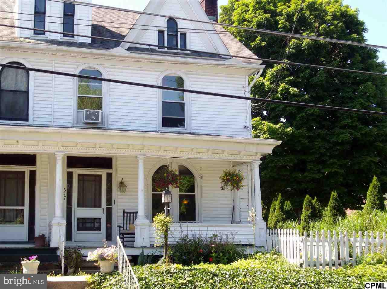 Victorian Charm w/ this spacious 3 bedroom 1/2 dbl. Open Staircase, replacement windows, Nice eat in kitchen plus formal dining room! First floor laundry, Living room w/ woodburning fireplace! Finished basement w/ woodburner. Large attic. Old carriage house & covered rr patio! Fenced yard! Rear lot for parking is included!
