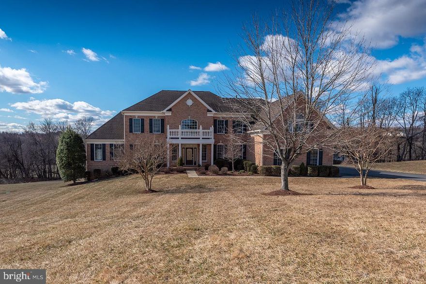 An Exceptional GEM in the Scenic Shenstone Community! Nestled on a stunning 3.72-acre private lot, this luxurious Toll Brothers Hampton Georgian model is the epitome of refined living. With over 5,800 square feet of elegant space, this home features three sides of brick and an impressive array of premium upgrades throughout. As you step into the grand foyer, you are immediately greeted by exquisite tumbled marble flooring and a dramatic dual staircase. The home’s open and airy feel sets the tone for the entire property. Designed for both culinary enthusiasts and those who simply enjoy gathering, the chef-inspired kitchen boasts a sweeping island, a wealth of tastefully crafted cabinetry, high-end stainless steel appliances, and a spacious pantry. Two large windows invite abundant natural light and offer peaceful views of the surrounding landscape. Step outside to the expansive deck, a perfect blend of comfort and style. Designed not only as a tranquil space to unwind, it also offers ample room to entertain family and friends while enjoying the serene surroundings. The family room features a striking stone gas fireplace, creating a cozy atmosphere that complements the generous space perfect for entertaining. A beautiful Sun/Florida room, located just off the formal living area, provides an additional retreat. French doors open to a private balcony, offering another peaceful area to enjoy the tranquil views. Both the formal living and dining areas are adorned with elegant molding and stunning chandeliers, making them the perfect setting for formal gatherings. One of the home’s unique features is the back staircase, which offers easy access to the family room and kitchen, ensuring convenience for daily living. This home also offers five generously sized bedrooms, each with its own private bath, providing the utmost privacy and comfort for family members and guests. The primary bedroom is a serene sanctuary, complete with a tray ceiling, an elegant chandelier, a cozy sitting area, and a spa-like primary bath. The bath features a step-down into a peaceful retreat with a soaking Jacuzzi jet tub, perfect for relaxation. Two large walk-in closets provide ample space for your wardrobe. For car enthusiasts, the upgraded three-car garage is a showstopper. Featuring Spartacote Chip flooring (with a multi-coat chip flake finish and UV-stable coating) and New Age professional cabinetry, this space is as functional as it is aesthetically pleasing. Whether for cars or organization, this garage is a standout. The garage also leads into a mudroom with a full closet, a powder room, and a spacious laundry room—ideal for managing everyday needs and keeping life’s necessities neatly tucked away. One of the standout features of this property is its proximity to the W&OD Trail. Whether you love walking, running, or cycling, you'll feel right at home. The trail is easily accessible, providing a perfect path for outdoor enthusiasts to enjoy. Located just a short drive from Leesburg, this home offers easy access to shopping, dining, wineries, breweries, and the unique shops that line downtown Leesburg. Step into this remarkable home and experience luxury living at its finest, with panoramic views and an unparalleled sense of tranquility.