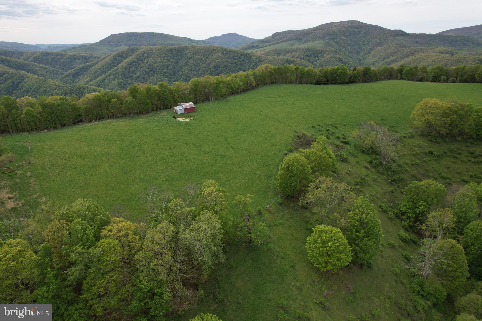 🏞️ 187 Acres Bordering National Forest – A Rare Opportunity in Wild & Wonderful West Virginia!
This stunning 187-acre property—comprised of two parcels (107 acres + 80 acres)—offers an unbeatable mix of open farmland, lush woods, and breathtaking mountain views. A true gem for hunters, homesteaders, or investors alike!
Located in close proximity to Seneca Rocks, this land stretches all the way to the top of the mountain, with select spots offering a direct view of the iconic rock formation. Approximately 50% to 70% of the property borders national forest, creating a rare opportunity for privacy, recreation, and endless exploration.
Property features include:
A large upper field ideal for farming or pasture, completely fenced and accompanied by a barn
An artesian well producing abundant water—enough to potentially supply multiple homes
Two spring-fed ponds perfect for wildlife, livestock, or relaxation
Rolling woodlands, ridges, and natural beauty throughout
Ideal terrain for hunting, hiking, riding ATVs, or future building sites
Whether you're dreaming of a private mountain retreat, a working farm, a recreational paradise, or a legacy investment, this land has the space, water, and freedom to make it happen.
Opportunities like this—especially with this much national forest frontage—rarely come available.