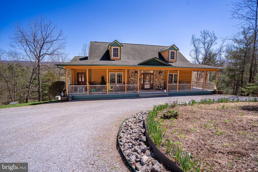 Exceptional Custom Built Mountain Home – The heart of the home is the great room, featuring a grand stone fireplace perfect for cozy evenings. Beautiful kitchen with granite counters and custom cabinetry, plenty of storage with pantry, island with gas cooktop and unique vent hood. Corner breakfast nook accentuated with large windows offering stunning views from every angle. Formal Dining Room for large gatherings provides area for exquisite furniture pieces. The gorgeous hardwood floors show off design highlights of natural wood finishes, 6 panel wood doors, trim, soaring ceilings, and large windows that flood the space with light. Luxurious primary suite with French doors to the deck, complete with a spa-like bathroom and walk in organizer closet. The walkout basement with two bedrooms and a full bath offers endless possibilities for customization. Ceramic Tile floors, large family room and plenty of additional space to add a kitchen! Options to finish another two bedrooms or create an office, game room, hobby room on the unfinished side. French doors lead to the slate patio under the expansive deck that spans across the back of the home.  There are two wet weather streams on either side of the house and an unnamed Sleepy Creek tributary running through the bottom land.  A gorgeous wrap around porch shows off the exterior finishes and stone at the entry. Other Extras include a whole house Generator, Owned Solar panels on roof suppling 1/3 of power, and Radiant heat floors in basement and primary bath. The Detached Garage fits two cars and has a workshop area AND a full bath with stall shower.  Upper level of the garage has walls and ceilings finished, many windows to let the light in, and can be completed for an amazing guest suite!  Make this home your family retreat, full time residence, or multi-generational 
 sanctuary, blending nature with very comfortable living.