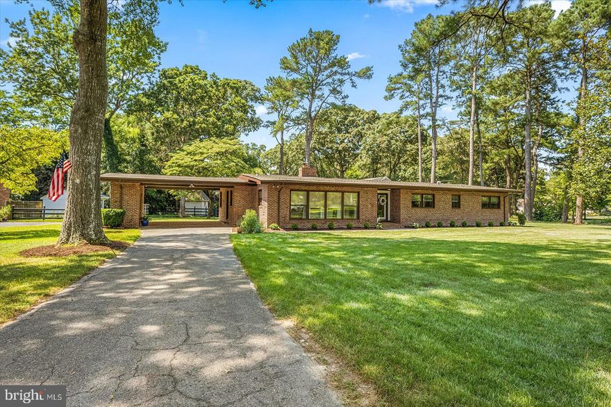 This exquisite mid-century modern residence is nestled within the meticulously landscaped Tony Tank neighborhood. Poised on a corner lot embraced by lush trees, this all-brick ranch home affords unparalleled privacy and a serene backyard retreat. Boasting a seamless single-floor layout, the residence comprises 4 spacious bedrooms and 2.5 baths. Recently renovated, this home epitomizes timeless elegance and attention to detail. Its impeccable upgrades include a new roof, windows, and sophisticated lighting fixtures, accentuating the allure of the stunning hardwood flooring that graces every room. The bathrooms have been tastefully modernized, while the electrical wiring, irrigation system, and backyard fence have been thoughtfully replaced and enhanced. The addition of a detached storage shed further enhances the functionality of the property. The heart of this home lies within its expansive kitchen adorned with custom cabinetry and state-of-the-art stainless steel appliances. A gracious living room awaits, complete with a charming wood-burning fireplace, while a seamlessly connected dining area leads to a captivating screened-in porch. Offering versatility and potential, the full basement encompasses a partially finished area, ideal for an office, playroom, or family room. The remaining half of the basement is currently utilized as a laundry and storage space but holds the promise of future expansion. The idyllic fenced-in backyard invites leisure and entertainment, with a patio adjacent to the porch, creating a harmonious setting for gatherings. Completing this remarkable property is a carport with additional storage, catering to the practical needs of the homeowner.  This home also has a bomb shelter area in the basement.  Call today for your showing!