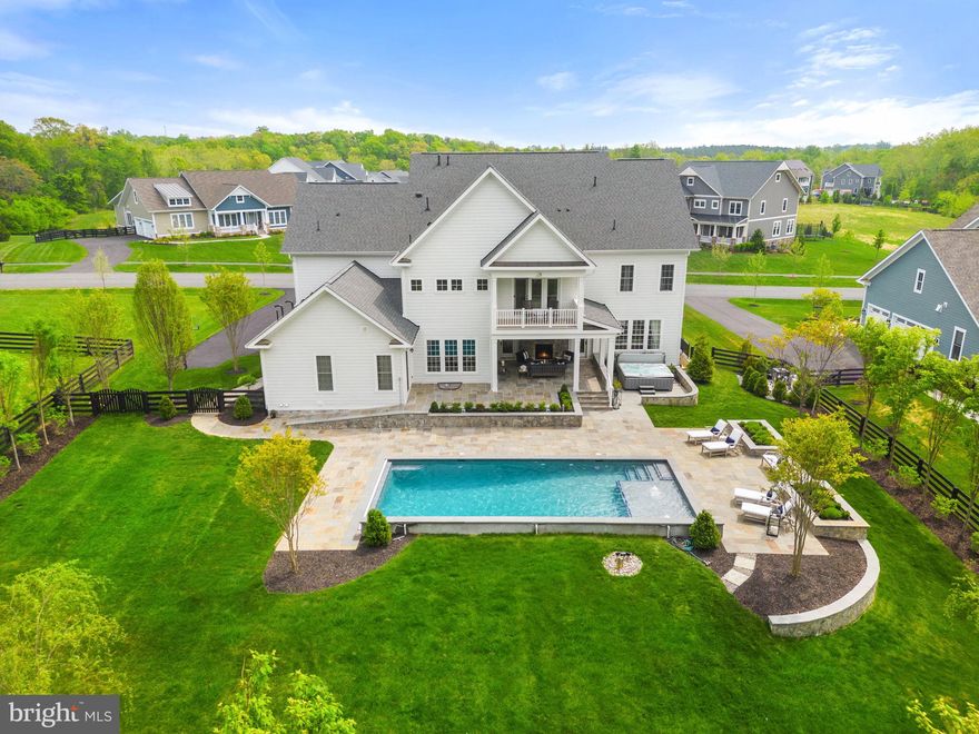 The Hamilton Model home at the Grant at Willowsford is truly a remarkable property that boasts luxurious amenities and features that are unparalleled. As you enter the home, you are greeted by a grand spiral stairway in the main entrance hallway that leads up to the upper level of the home.
The upper level of the home features five suites, each with its own private bathroom, and three decks that offer breathtaking views of the surrounding landscape. The sound system throughout the inside and outside of the house creates an immersive audio experience that further adds to the luxurious ambiance of the home.
The luxury landscaping surrounding the home is truly a sight to behold, featuring a swimming pool with a fountain, a hot tub for 10 people, a covered porch, and a screened porch that provides ample space for outdoor entertainment and relaxation.
The primary suite is an absolute masterpiece, with a sitting area and deck that provide a serene and private oasis. His and her massive and grand walk-in closet is like nothing you have ever seen before, providing ample space for all your clothing and accessory needs.
Tray ceilings and multiple trims throughout the entire house add an extra layer of elegance and sophistication to the property, while the upgraded natural wood floor throughout the house provides a warm and welcoming feel.
The custom-built laundry room with a walk-in closet is both practical and functional, while plantation shutters everywhere provide privacy and light control.
The just-finished basement is a massive 2,000 sqft. and features a variety of entertainment and relaxation areas that are perfect for family gatherings or hosting events.
The kitchen is a chef's dream, featuring Wolf appliances, a subzero refrigerator, two sinks, two large counters, two dishwashers, a built-in microwave, and a double oven wall. The morning room provides a beautiful view of the outdoor landscape, while the butler's pantry and beautiful dining room offer ample space for hosting dinner parties or other events.
The full suite on the main floor with laundry and disability access provides a convenient and accessible space for guests or family members with mobility needs. The see-through fireplace in the large family room adds a touch of warmth and comfort, making this home truly a one-of-a-kind property.