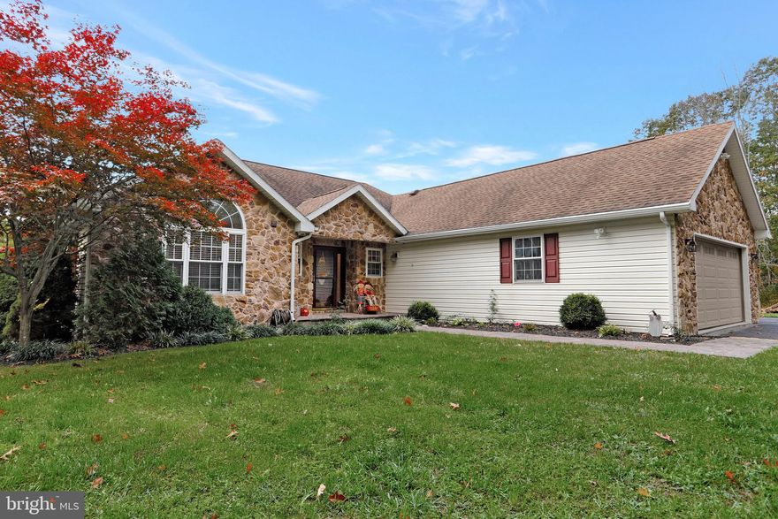Beautiful contemporary rancher on 2/5 +/- Acres just minutes from downtown Berkeley Springs and easy commute to Martinsburg WV and Interstate 81.   Main level features 3 BR, 2BA, open Kitchen/Dining and LIving Room with Stone gas fireplace.  Access to the rear deck, which spans the length of the house.  Laundry room with stack W/D used to be a half bath and can easily be converted back to a half bath.  Mud Room off the 2 Car Attached garage used to be the laundry room, which still has the hook ups and can be converted back to the laundry area.  Full, Finished basement features a large Family Room, which has walk out entrance to a stone patio.  Large bar area with sink, game room, office/den, 4th bedroom and full bath.  No restrictions and no HOA.   Detached oversized 2 car garage would be perfect for a workshop, studio, craft room, the possibiilties are endless!