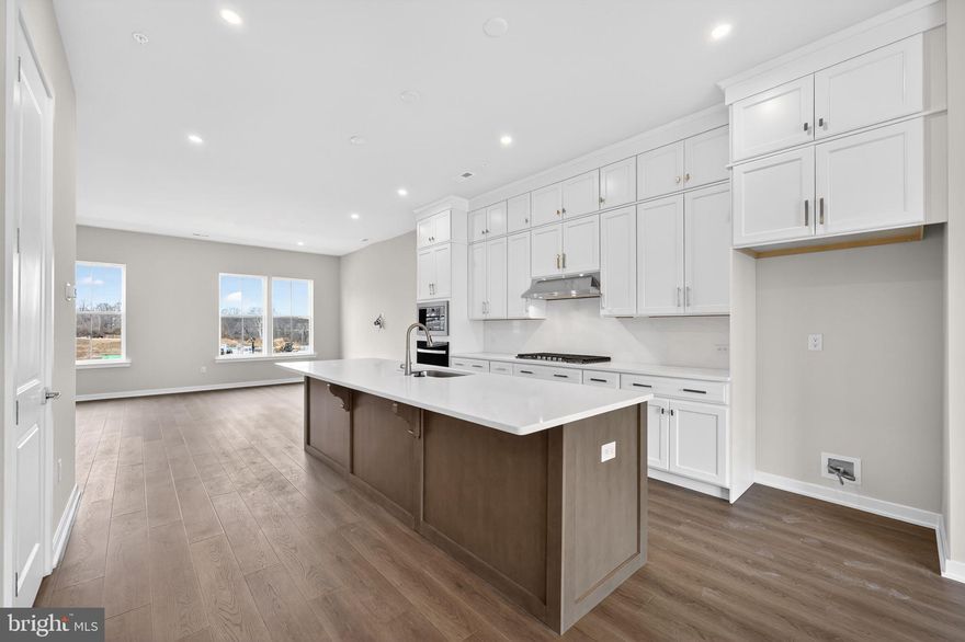 Welcome to 110 Lizabetta Lane located within King of Prussia's River Trail at Valley Forge community!

Timeless in its design and generous in its layout, this 4-bedroom, 3.5-bath  townhome offers a roomy 2-car garage and a pre-planned elevator rough-in for effortless living down the road. The entry level welcomes you with a private guest suite complete with its own full bathroom and direct access to the backyard an ideal retreat for overnight guests or a quiet space to work from home.

The main level makes an immediate impression with its soaring 10' ceilings. The dining area opens directly to an elevated composite deck, creating a natural flow for indoor-outdoor entertaining. The oversized chef’s kitchen showcases soft-closing, ceiling-height cabinetry, quartz countertops, and an island with generous breakfast bar seating.  A walk-in pantry and dedicated coffee bar add both function and luxury, while the premium appliance package includes a gas cooktop with a hood above and a built-in wall oven and microwave. The great room, lined with oversized windows facing west, is perfectly positioned to capture unforgettable sunset views each evening.

Upstairs, the primary suite is situated at the back of the home and includes a  raised ceiling, two walk-in closets and an attached bath with walk-in shower and quartz-topped dual sink vanity. Two additional bedrooms, a full hall bathroom, and laundry room complete the sleeping level of this move-in ready townhome.

Located in the vibrant River Trail at Valley Forge community with direct access to the Schuylkill River W Trail, leading straight to Valley Forge National Park ideal for outdoor enthusiasts and weekend adventurers.  This home is ready for immediate move-in or early 2026, and the community also offers homes you can personalize with move-in timelines extending through Spring/Summer 2026.