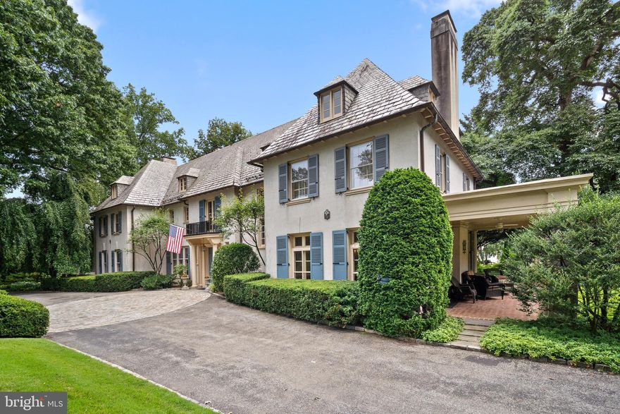 Welcome to "By the Wood," a stately historic home located in the prestigious Northside of Haverford. This remarkable residence has been meticulously maintained and renovated over the years, preserving its architectural grandeur while seamlessly incorporating modern conveniences. The grand foyer welcomes you with beautiful hardwood floors, high ceilings, intricate moldings, and elegant rooms. The front-to-back living room features a marble fireplace and French doors opening to a covered porch, patios, and stunning grounds. Ideal for gatherings, this space is complemented by a large dining room with another fireplace and an adjoining butler's pantry. The well-equipped kitchen boasts a large eat-in island, gas cooktop, double ovens, and stainless-steel refrigerator, opening into a family room with views of a charming walled courtyard garden. Additional rooms include a cozy den with built-ins and a fireplace, and a spacious powder room. The home features a grand front staircase and a secondary staircase leading to a curved ceiling hallway, a sitting area with a Juliet balcony, six bedrooms, three full bathrooms, and a sunroom. The main suite offers a marble fireplace, a walk-in closet, and an expansive bath with double sinks, a shower, and a soaking tub. A secluded sunroom off one of the bedrooms provides a serene retreat. The third floor includes four additional bedrooms, a hall bath with a clawfoot tub, and a large unfinished storage area with rooftop access, perfect for stargazing. Situated on 1.2 acres of flat, well-maintained grounds, this property features a cobblestone circular detail with a compass, a water feature, and a sweeping driveway with ample parking. The expansive side yard is perfect for games and entertaining, while the private rear brick patio, accessible from multiple French doors, is ideal for grilling and relaxing. This rare gem is within walking distance to the Merion Cricket Club, Haverford Square, and the station. Located in the award-winning Lower Merion School District, this home is the ultimate Main Line estate, blending historic elegance with modern luxury. Don't miss the opportunity to own this exceptional property in a highly desirable neighborhood.