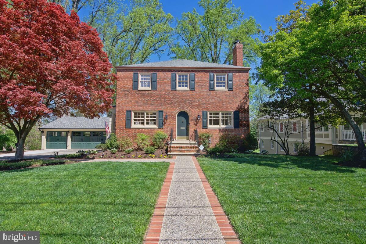 From the moment you approach this beautiful center hall colonial home, RENOVATED in 2020, the classic architecture and old-world charm are certain to impress even the most discerning buyer. Wrapped in red brick and appointed with period-style lighting and an arched front door, the timeless exterior is perfectly juxtaposed by the masterfully renovated interior. Elegant hardwood flooring, crown moldings, designer lighting and bay windows enhance the freshly painted living spaces. The main level features a spacious home office with a bay window, a formal living room with a wood-burning fireplace, a dining room, and the kitchen of any chef’s dreams. Custom cabinets are adorned with full overlay doors and topped with Cambria quartz. The large island has 2.5” mitered-edge finishing, storage on all sides and a wine cooler. Professional-series appliances include gas double ovens and a built-in microwave drawer, and the under-cabinet lighting is controlled remotely. A lovely casual dining space overlooking the lawn adjoins the kitchen. Perfect for entertaining, the kitchen opens to an expansive family room with double French doors leading to a deck. Mindful of the needs of the modern family, a mudroom/laundry room includes built-in cubbies and a bench, extra storage cabinets, a sink and a separate side entry. A half-bath, two coat closets and another closet with custom shelving completes the main level.
Upstairs there are four bedrooms and three full baths, all offering fresh paint and hardwood flooring. The primary suite is luxurious, with two walk-in closets and a spa-like bath with new tilework, a double vanity, Kohler soaking tub and an oversized shower. All the bedrooms feature ample space for furnishings and clothes, and bedroom two has an ensuite full bath. The hall bath has been fully renovated with a double vanity, a walk-in shower and a large linen closet.
The lower level has abundant sunlight and offers a recreation room with potential for a fifth bedroom, a full bath, and a utility room with storage space and an extra refrigerator. New doors in the lower level open to a large covered patio and the amazing lawn and sport court area. This residence enjoys a 20,000 square foot lot with mature trees in the back and ample space for play, gardening, an Olympic-size pool, or any of the outdoor living amenities you dream of. The carriage-house style 3 car oversized garage adds the perfect complement to the country manor vibe of this home, and features new doors, lighting, cabinets and a bay window. Nestled on one of Chevy Chase View’s most beautiful streets, this fabulous home checks every box for the luxury buyer seeking the finest craftsmanship with both old world character and state-of-the-art livability.