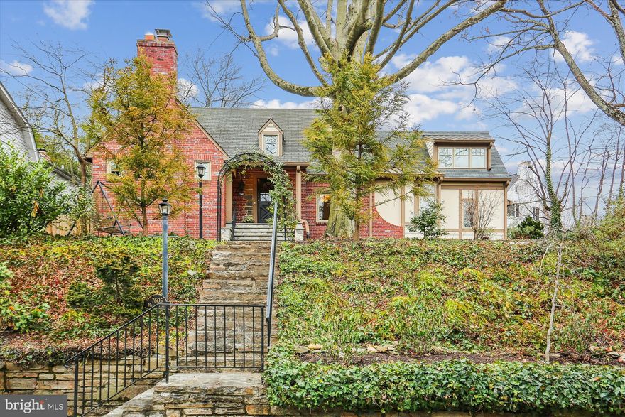 Set up on a hill, on a large (11,797 sq ft) and beautifully landscaped lot, this utterly enchanting Cape Cod/Tudor home is surprisingly spacious and full of charm and character. Renovated and expanded in 2013 this home boasts a unique and open floor plan.  First floor features: an elegant, oversized dining room with paneled walls, cozy fireplace and cathedral beamed ceiling; 3 BRs all with en-suite bathrooms; a large family room with fireplace, cathedral ceiling, and dining area; and a bright white kitchen with stainless steel appliances, peninsula, and sitting area. On the sun-drenched second floor, there are 2 BRs, a den, and a full BA. The finished lower level has a laundry area , Play/Rec. area and storage closets,. Exterior features include: extensive Lanscaping includes a large, private, slate patio with soothing water feature; numerous stone retaining walls and a deep, wide front yard. A large parking pad with EV charger and detached Garage with additional  Parking spot allows for flat entry into home.  Under a mile to Bethesda Chevy Chase High School and Chevy Chase Elementary, and Just  one mile to Bethesda METRO, restaurants, and shopping. This home offers the privacy of suburban living with easy access to the sought-after features of an urban home.   
OPEN Sat (2/3 and Sun 2/4) Noon to 2pm