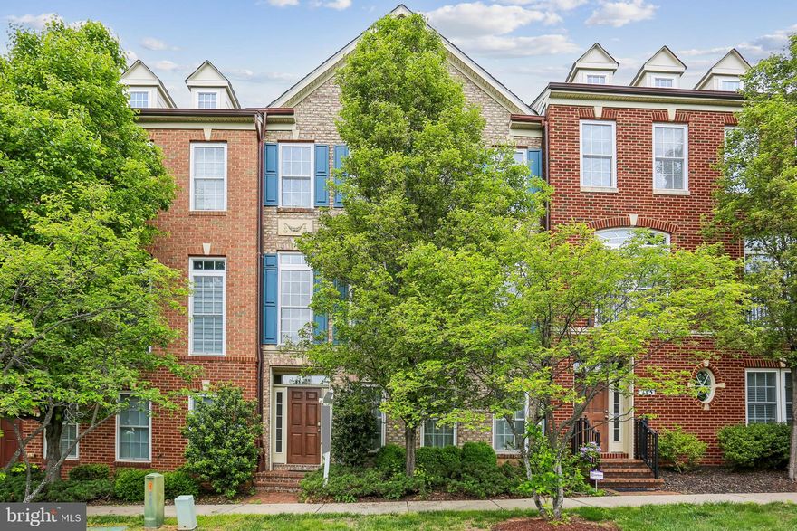 This former model home offers exceptional upgrades, expansive living areas, and a like-new feel across three finished levels. The entry level includes a spacious and versatile recreation room with hardwood flooring, recessed lighting, and three oversized windows overlooking an expansive green space. A half bath features a granite-topped vanity with vessel sink and linen closet. Additional features on this level include a coat closet, a utility/storage room and access to a two-car garage with extra space for storage. A hardwood staircase with custom runner and decorative lighting leads to the main level, where hardwood floors continue throughout. The open layout includes a large living room with a wall of windows and green space views, and a dining area finished with crown and chair moldings and a decorative chandelier with medallion. The large family room features a gas fireplace and adjoins the kitchen, upgraded to include granite countertops, a tiered granite island with breakfast bar, stainless steel appliances, upgraded cabinetry, decorator lighting and fixtures, and a pantry closet. The butler’s pantry area provides additional storage and prep space. A big breakfast affords French door access to the large deck. Highlights of the upper level include the primary suite with hardwood floors, lighted tray ceiling, a walk-in closet with a custom organizer system, and a spa-like en-suite full bath with dual granite-topped vanities, a walk-in shower with custom tile and glass surround, decorator lighting, a compartmented water closet, and linen closet. Two additional bedrooms include high ceilings, double-door closets, and offer lovely sunset views. The upgraded hall bath features granite countertops, upgraded tile, a vessel sink, and a furniture-grade vanity. Conveniently located on this level,  the laundry room includes a newer washer and dryer. Recent mechanical updates include a 2023 HVAC system and a 70-gallon water heater installed in 2025. Additional features include a built-in security system and passive radon remediation. Located near Downtown Crown with access to countless shops, dining, entertainment options as well as close access to major commuter routes, this home has it all!