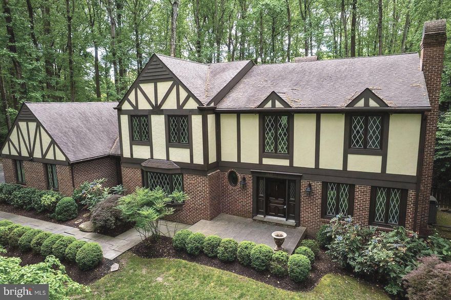 Welcome to 10217 Wendover Drive—an enchanting, storybook Tudor nestled on a beautifully wooded and private 2-acre lot in the heart of Vienna. This one-of-a-kind residence offers nearly 5,000 square feet of well-designed living space and a versatile floor plan featuring the highly sought-after 4 bedroom, 3 bathroom configuration on the upper level.

Step into the gracious marble foyer, where an elegant circular staircase sets the tone for the timeless charm and sophistication found throughout the home. The formal living and dining rooms, positioned on either side of the entry, offer refined spaces ideal for entertaining and special occasions. A main-level library provides a quiet, light-filled retreat—perfect for working from home.

The spacious kitchen with breakfast nook overlooks the serene backyard and opens seamlessly to the cozy family room with a traditional brick fireplace—an inviting space for gathering and relaxing.

Upstairs, the home continues to impress with a well-laid-out bedroom level including a large primary suite featuring a tranquil sitting area and ample closet space, a guest suite with a private bath, and two additional generous bedrooms sharing a hall bath.

The walk-out lower level expands the living space even further, offering a large recreation room, and a bar area with  a wine cellar that adds to the home's unique character and charm.

Outdoor living is truly exceptional. A screened porch provides a peaceful place to enjoy nature, while the expansive backyard—accented by mature trees and an outdoor fireplace—is perfect for gatherings under the stars.

This cherished home presents endless opportunities for personalization and provides excellent value. The original kitchen and bathrooms offer a neutral palette, awaiting your creative vision to transform them into spectacular spaces. 

Located just minutes from the Oakton Shopping Center (featuring Giant, CVS, Starbucks, and dining options) and the vibrant Church Street corridor in Vienna with its small-town charm, locally owned shops, and access to the W&OD Trail the location offers the ideal mix of privacy with easy access to amenities. Commuters will appreciate the close proximity to major thoroughfares and the Orange and Silver Line Metro stations.

Excellent public and private school options, Madison HS pyramid (Flint Hill Elementary, Thoreau Middle, and Madison HS) and nearby private schools - Flint Hill and Oakcrest.

Don't miss your chance to begin your next chapter in this truly magical home.