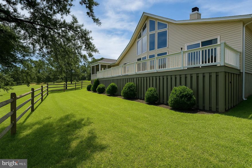 This newly designer-updated home sits on the 6th fairway of the Mountain View Golf Course, tucked away on Wampum Lane—a quiet street lined with large, lovely homes adjoining the course. At the center of the home is a striking three-sided, wood-burning natural stone fireplace with a raised hearth that rises to meet exposed wood beams of the cathedral ceiling. This dramatic architectural feature is rivaled only by the wall of windows that brings in sweeping views of the rolling green fairway, a stunning visual that beautifully contrasts with the interior’s warm palette of pale yellow tones and modern black accents. The home includes three bedrooms, two bathrooms, a spacious open loft, and a detached two-car garage with storage. With its vaulted ceilings and open design, the home has a bright and expansive feel that’s both inviting and stylish. It’s perfect for entertaining, with a modern kitchen that flows into the dining and living areas, as well as out onto the large rear deck and a comfortable screened-in porch. The kitchen features Yorktown maple cabinetry, Corian countertops, and under-cabinet lighting. The interior and exterior have been freshly painted, and designer lighting fixtures were recently installed throughout. Both bathrooms have new faucets and trim. Hardwood flooring runs through the main living areas, tile accents the kitchen, and plush carpet adds warmth in the bedrooms and loft. Outside, the home’s paved driveway is bordered by extensive hardscaping for low-maintenance curb appeal. Recent improvements include a brand new grinder pump and a new 50-gallon water heater, both installed following a completed seller’s home inspection. A rendering shows a potential split-rail fence layout to help buyers visualize the large side and rear yard, and this fence type is permitted by the HOA. The property also qualifies for a Woods Club Membership, offering access to indoor and outdoor pools, tennis, golf, spa services, and more. Whether you’re looking for a full-time residence or a luxury golf-course retreat, 477 Wampum Lane offers turnkey living in one of the most desirable pockets of The Woods. All design and staging by Honey House. All documentation is available.