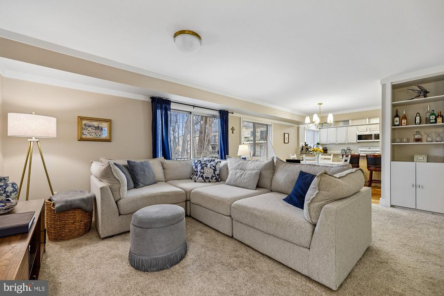 FIRST OPEN HOUSE, SATURDAY, 3/21, 2PM-4PM.  This exceptional two‑bedroom, two‑bath residence offers the perfect blend of comfort, style, and location. From the moment you enter, it’s clear this home is special. A welcoming foyer with a generous closet opens into an expansive living and dining area, ideal for both everyday living and entertaining. Thoughtful accents and finishes enhance the space throughout, including classic crown molding, new light fixtures, and a striking modern chandelier.
The open floor plan flows seamlessly to a private balcony—your own peaceful retreat overlooking lush, tree‑lined views. It’s the perfect place to enjoy your morning coffee or unwind at the end of the day.
The well‑appointed kitchen features floor‑to‑ceiling cabinetry, a convenient bar area, durable LVP flooring, and a picture window that fills the space with natural light. Storage is abundant throughout the home, including built‑in shelving in the living area, a large hall linen closet, a roomy kitchen pantry, and spacious bedroom closets.
The home offers two comfortable bedrooms and two fully renovated bathrooms, including a primary suite with a private en‑suite bath and a ceiling fan for added comfort. Additional highlights include a dedicated storage room and the convenience of all utilities included in the condo fee.
Ideally located just minutes from Grosvenor Metro, shopping, schools, parks, and major commuter routes including I‑495 and I‑270.
Move right in—no updates needed. Just unpack and enjoy.