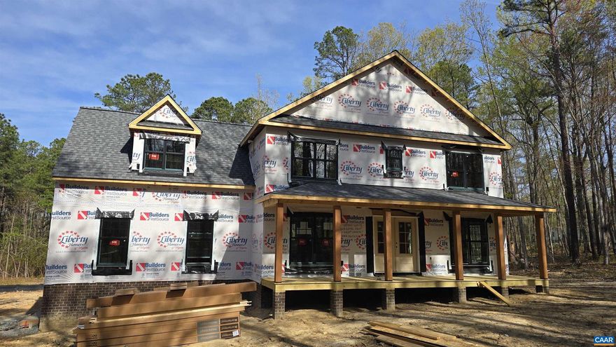 READY FOR INSULATION (4/9) The Magnolia model, sited on 22 acres, with upgrades galore both inside and out! Interior upgrades include Laminate Flooring throughout the entire first floor, black interior hardware package, spacious great room with extra lighting, dining room with craftsman trim package, gourmet kitchen with quartz countertops, 2x7 island with pendant lights, Tier 2 42? cabinets, stainless steel appliances and farmhouse sink, spacious pantry, mudroom and half bath finish out the main level. Take the oak stairs with craftsman railing, ceiling fan with light and craftsman trim vertical package in primary bedroom, 5' tile shower and flooring in primary bathroom with transom window and double bowl vanity, LED lights in the 3 bedrooms, pull down attic stairs with storage, and adult height toilets in primary and half baths. 2 zone HVAC. Exterior upgrades include sideload garage with opener, black windows and gutters on front elevation, craftsman shutters, full front porch with wrought iron rails, French front door with 3/4 glass, extra windows, 12" board and batt are above the Front Porch, stained gable, and 10x14 rear deck. Late fall completion!  Photos are similar. Ask how you can save $7,500 in closing costs!,Quartz Counter,Wood Cabinets