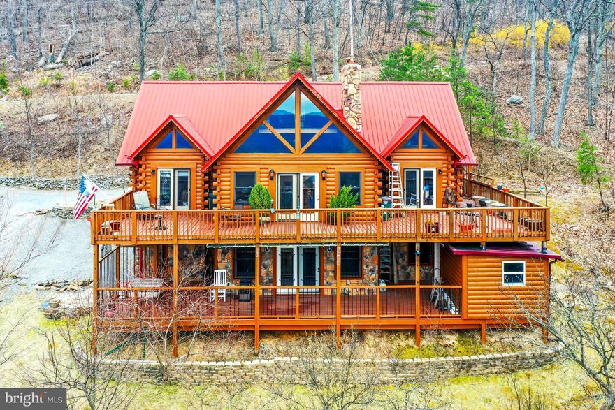 Extremely private gorgeous three level log home on 9.6 acres that has to be seen to be believed. Sitting high on the mountain, the view goes on forever with the Potomac River meandering along the valley floor. Upper and lower decks allow you to enjoy watching the sun set, the snow fall, and the wildlife playground below. Open floor plan, floor to ceiling fireplace, stainless steel appliances, European bath, built for 3 bedrooms. Multiple different mature fruit trees adorn the property.