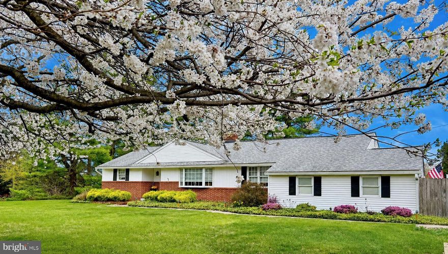 Beautifully maintained and thoughtfully updated, this exceptional ranch home offers effortless one-floor living, situated on nearly an acre in one of Bucks County's most desirable locations, just moments from shopping and the charm of Newtown Borough. Blending comfort, accessibility and convenience, this 3-bedroom, 2-bath residence is ideally positioned with easy access to most major highways.  Inside, gleaming hardwood floors extend throughout, leading into a sun-filled living room with a stunning bay window and a gas-converted fireplace, creating a warm yet elegant focal point.  The open floor plan flows seamlessly into the dining room, ideal for everyday living and entertaining. The updated eat-in kitchen is as functional as it is stylish, featuring granite countertops, a center island, gas cooking, and abundant cabinetry. A true highlight of the home is the four-season room with an attached greenhouse, perfect for year-round enjoyment or the avid horticulturist, opening to a paver patio with new awning for effortless indoor-outdoor living. The primary bedroom features a well-proportioned layout with dual closets and an updated, expanded en-suite bath. Two additional bedrooms offer flexible space for guests, a home office, or both. The refreshed hall bath is filled with natural light and showcases a clean, modern finish. Storage is truly abundant with generous closets, a walk-up attic with future finishing potential, and a spacious basement complete with a workbench and air compressor, ideal for hobbies, projects, or organization.  Additional features include an attached 2-car garage, expanded driveway, maintenance-free exterior, updated mechanical systems and newer roof. This exceptional home offers easy living, tasteful updates, and room to grow in a premier location known for its convenience and appeal.