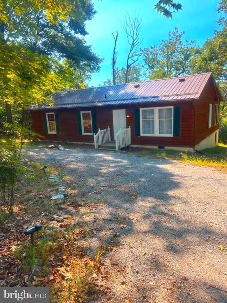 Welcome home to this updated rancher nestled in the woods! Featuring a open kitchen, real wood floors, main floor laundry, and a sunroom off the back, this  almost 1300-square-foot, 3 bedroom/2 bath home has a very practical floor plan and is move-in ready. Enjoy the privacy of the wooded lot from the back deck and the convenience of the half-circle driveway with plenty of parking. The metal roof is ideal for minimal maintenance, and there's also a workshop that provides extra storage space. This property even has a propane back-up generator! Located in the Blue Ridge Acres community, river and community pool access are available for an annual fee. The close proximity to Rt.340/Rt.9 makes it a great spot for commuters as well. Now's your chance to make this home your own!