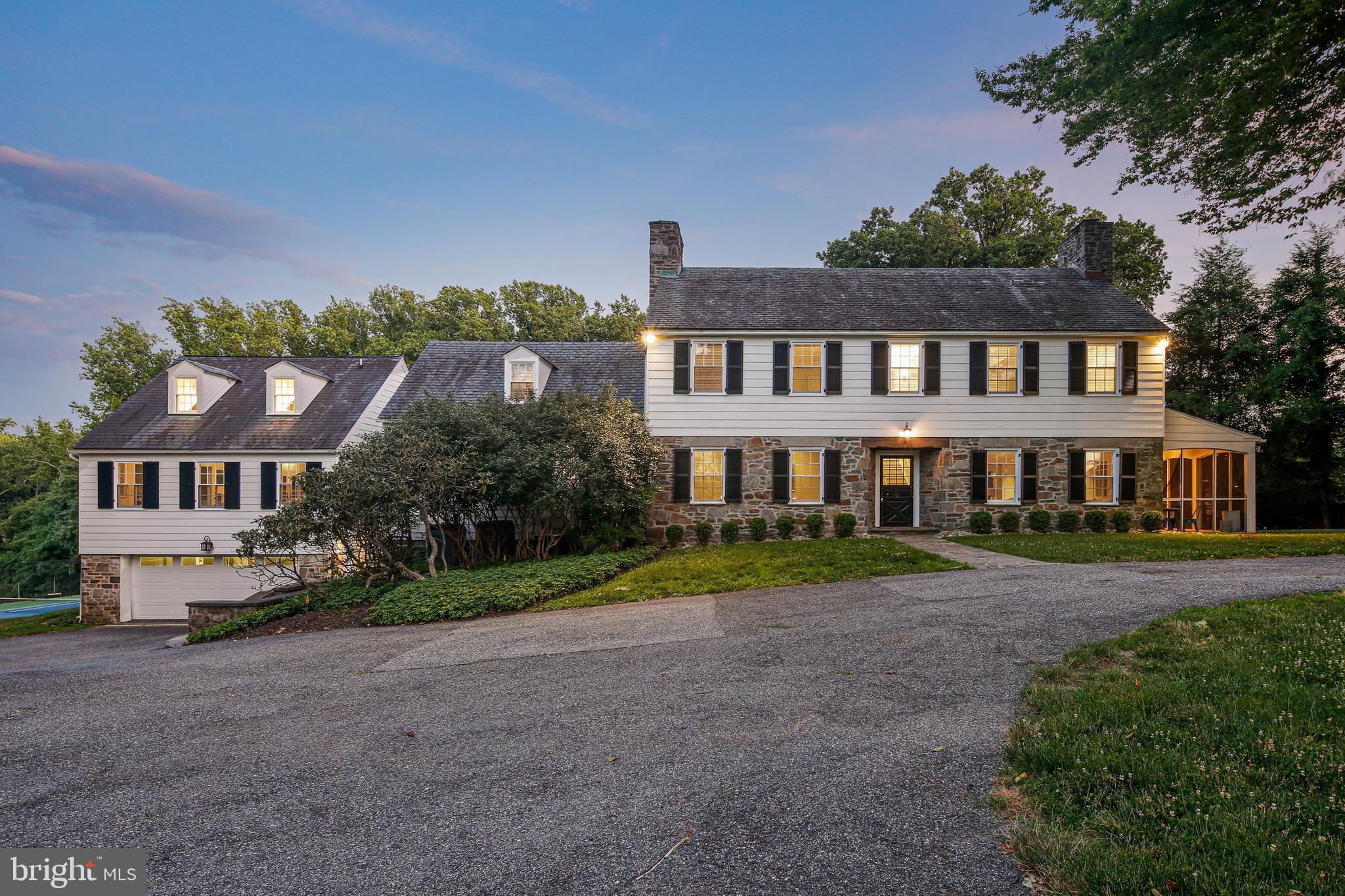 The best of old-world charm! This combination stone/siding manor house built circa 1935 with major rehab completed in 2016 is perfect for entertaining both inside and out. The welcoming circular drive, mature landscaping, extensive tiered hardscape with large stone patio, screened in porch, tennis court and two putting greens all on nearly 4 acres afford privacy and maximum enjoyment. With nearly 6000 sq ft, this colonial home has been thoughtfully renovated combining classic, stately features with modern conveniences. Setup with 6 bedrooms and 5 full and 2 half baths, the home boasts 4 finished floors, and makes great use of its space and affords natural light at every turn. There are natural hardwoods, cathedral ceilings, and tons of built-ins everywhere. Gourmet kitchen with center island with cooktop and pendant lights and barstool seating. The living room and den/office both have fireplaces, are cozy and spectacular and the great room has a vaulted ceiling. Laundry is on main floor. Two-car garage on the lower-level with additional finished space, complete with full bath and tons of storage. In the heart of Pikesville, close to 695, this home is perfectly situated near golf courses, shopping, restaurants, and easy access to major arteries. Don’t delay! Come by and make this stunner all yours!