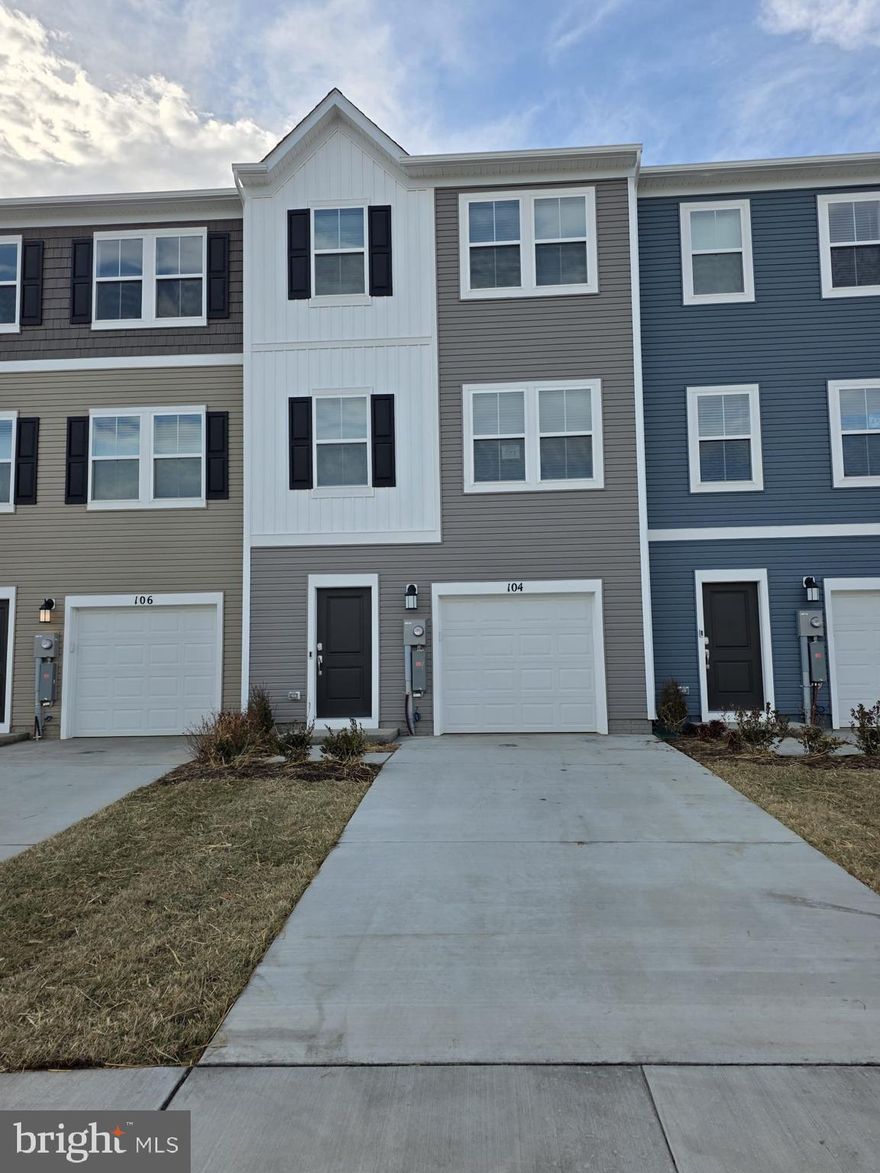Welcome to The Gallery, one of Martinsburg's newest communities! Conveniently located near shopping, dining, recreation, and just minutes from I-81, this home offers both comfort and accessibility.

Step inside this beautifully designed three-level townhome. The entry level features a spacious recreation room that can be used as a home office, media room, or additional living space, along with access to the one-car front-load garage and backyard.

Upstairs, the main level offers an open-concept layout connecting the kitchen, dining area, and great room perfect for everyday living and entertaining. The kitchen is equipped with stainless steel appliances and ample cabinet space, and a convenient half bath is also located on this level.

The upper floor is dedicated to comfort and privacy, featuring three well-sized bedrooms and two full bathrooms. The primary suite offers a spacious layout with a private en-suite bath and ample closet space. The additional two bedrooms are ideal for family members, guests, or a home office setup and share a full hallway bathroom. This level provides a functional and comfortable retreat at the end of the day.

Homes in this desirable community rent quickly submit your application today and secure this beautiful home before it's gone!