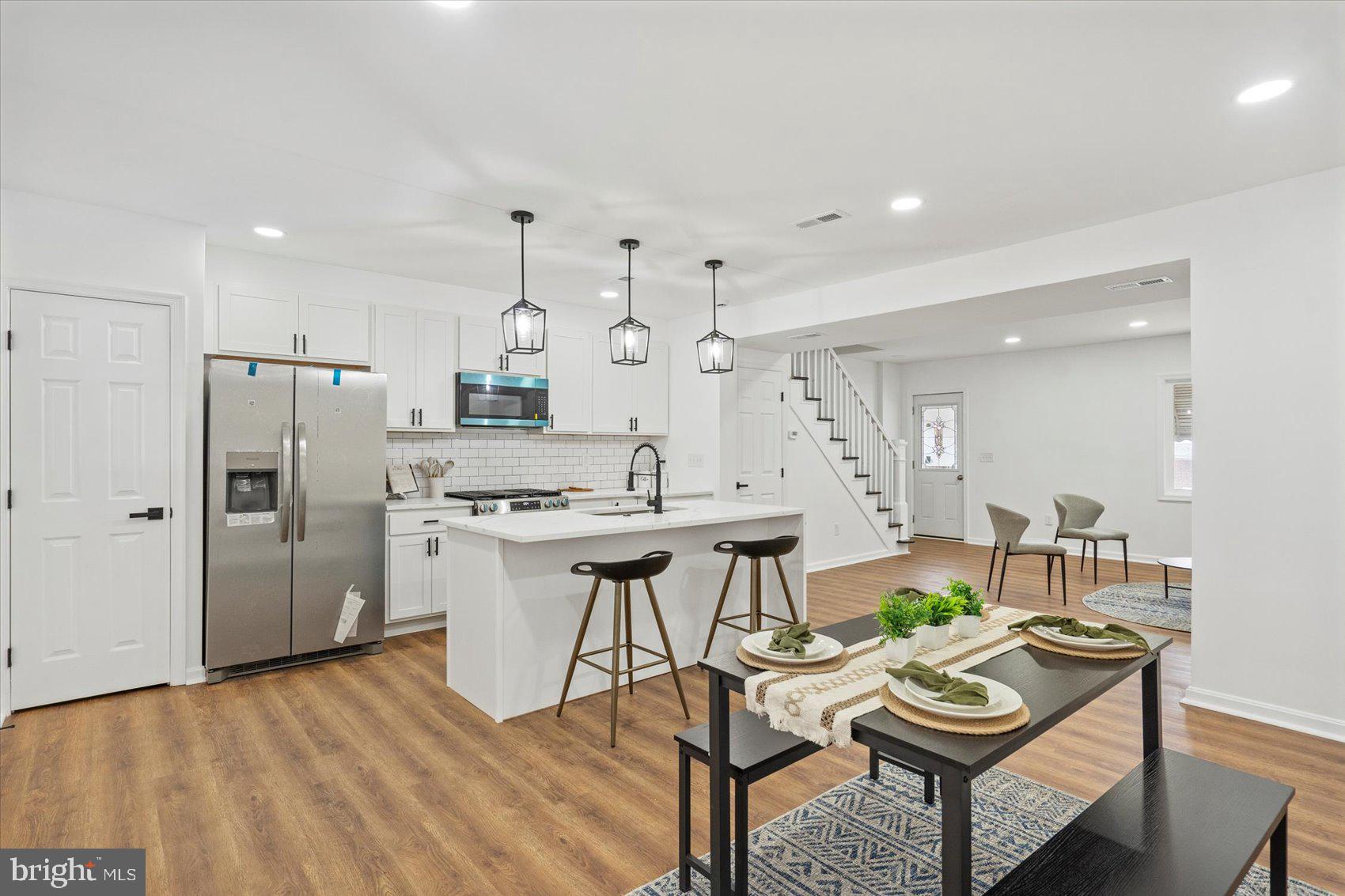 Newly remodeled 4BR/2BA brick Townhome located on a quiet street in the neighborhood of Berea. Make your way to the covered front porch, and open the door into your new home. Step into a stunning main floor boasting an open floor plan, tons of natural light, luxury flooring, and recessed lighting. This floor offers a large living room, spacious dining room, and stunning kitchen. The kitchen features plenty of cabinets, a separate pantry closet, brand new stainless steel appliance including a slide-in gas range, quartz countertops with a subway tiled backsplash, and a deep stainless sink set into an island with pendant lighting and breakfast seating for two or more. On the second floor is a large primary sized bedroom, two sizable secondary bedrooms, and a beautifully remodeled full bath with a vessel sink vanity. The lower level features additional living space which includes the fourth bedroom, a full bath with a vessel sink vanity, a laundry closet, a spacious family room, storage, and a walk-out to the fenced yard. From the kitchen step outside to a covered dual purpose patio/parking pad ideal for parking at least two cars, or for entertaining family and friends. This home is move-in ready with so much to offer new homeowners, and is located in close proximity to shopping, restaurants, and commuter routes.