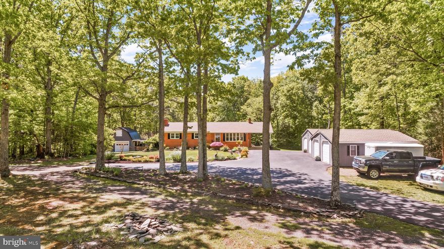 Country living as its very best for the mechanic or your own farmette.  Horses are welcome!    Over 5 acres of privacy on this hidden treasure.   A new Conventional Septic system will be installed and replaced by the end of the month!!!  Bricked rambler is loaded with upgrades.  Seller has taken much pride and renovated the entire home to include a new custom kitchen with granite counter tops and upgraded stainless steel appliances.  New hardwood on the main level, all three baths have also been remodeled.  3 bedrooms on the main level, lower level has a possible 4th however this could  also be used an office.  Lower level is fully finished with a hug Recreation room and fireplace.  A New roof on home and both garages.  Windows were replaced in 2012.  Brand new Washer & Dryer.  Enjoy evenings over looking the well  groomed yard from the privacy of your deck or from the warmth of your hot tub.  This home is so unique with a car port but also two large Amish built two car garages, each is 28 x 24.  Garages offer power.  Owner currently uses one of the garages as a personal gym.  The large run in barn in the back part of the property may offer shelter to any farm animals, equipment or another garage or workshop.  The barn (size 20 x 22) also connects the the fully fenced yard.  A great location for a horse or two.  The barn has a second level loft with 9.5 ft ceilings.  Just added a new water softener system. Deep Well was replace 12 years  ago.   Dirt bikes and 4 wheelers are a must have on this protected lot.  MIR race track just 2 miles away.  Wicomico Shores Golf Course & Boat Ramps just minutes away.  Since the acreage meets county requirements, property  can be  zoned agricultural for additional tax benefits. The landscaping is top notch.  The possibilities are endless.  NO HOA!