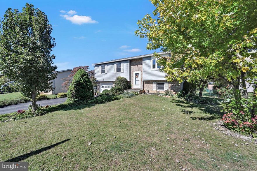 Welcome to 1105 Showers Lane in Muhlenberg Township. Open the door and step up into your living area with lovely laminate flooring and a new bay window to let in abundant sunshine. Continue through the living room into the eat in kitchen area, which opens onto the rear deck where you have a beautiful view of your large backyard where you can enjoy outdoor fun. Completing the upstairs level are three bedrooms and a full bathroom with ample  storage space. On the lower level, you will find a spacious area for entertaining and a combination laundry and powder room. Added bonuses are the recently installed water softener system, air conditioning, roof, gutters, and soffit. There is definitely a lot of like at 1105 Showers Lane!  This home is being sold AS IS.