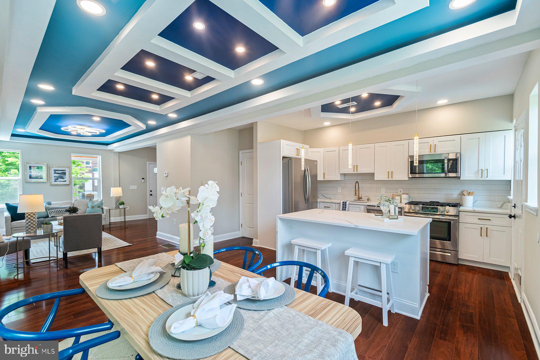 Welcome to this beautifully renovated townhouse in the heart of Baltimore! Step onto the spacious front porch—perfect for sipping your morning coffee or relaxing after a long day. Inside, you're greeted by gleaming hardwood floors and an inviting living room with a stunningly detailed ceiling that adds character and charm. A convenient powder room is located just off the main living area.
The open-concept layout flows effortlessly into the bright dining area, filled with natural light—ideal for entertaining or enjoying meals with family and friends. The kitchen strikes the perfect balance between modern style and everyday functionality, featuring stainless steel appliances, ample cabinet space, and a large eat-in island that’s perfect for gathering or meal prep.
Upstairs, the spacious primary suite offers generous natural light, great closet space, and a private en-suite bathroom. Two additional bedrooms and a full hall bath complete the upper level.
The finished lower level is ready for fun—whether you envision a game room, home theater, or playroom, there’s plenty of flexible space to make it your own. You’ll also find a fourth bedroom, an additional full bathroom, and a private walkout entrance—making it perfect for guests or an in-law suite.
Outside, enjoy a fully fenced backyard with space to grill, garden, or play with pets. A rare private parking pad adds everyday convenience. Don’t miss the opportunity to call this stylish and spacious home yours!