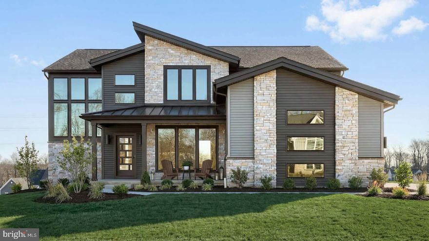 Striking contemporary home features a stylish exterior, 3-car, side-load garage with mudroom entry, and 9’ ceilings in the daylight basement and on the first floor. A 2-story foyer creates a dramatic first impression and stylish vinyl plank flooring flows from the foyer throughout the main living areas. The formal dining room is accented by a wood trim detail on the far wall and opens to a butler’s pantry, perfect for entertaining. The great room is warmed by a gas fireplace with modern floor-to-ceiling stone and has plenty of natural light from the large windows. Enhanced cabinetry and appliances, quartz countertops with a tile backsplash, and a large island adorn the spacious kitchen. Adjacent to the kitchen is a breakfast area and a sunny morning room with sliding glass door access to the composite deck offering stunning views. The 1st floor also features a study tucked quietly to the back of the home. On the 2nd floor, the owner’s bedroom feels spacious with a cathedral ceiling and opens to a private bathroom complete with a tile shower, two vanities, a freestanding tub and an expansive closet. There are 3 additional bedrooms with enlarged closets, 2 full bathrooms including a Jack and Jill bathroom, and a convenient laundry room.