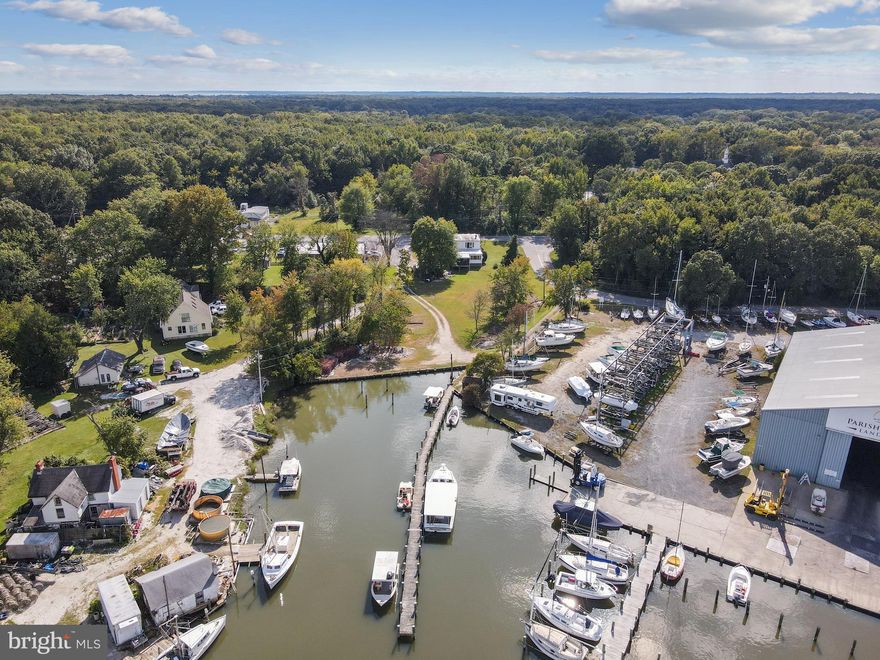 4 BEDS/1FULL BATH AND1/2 BATH WITH SHOWER. 2144SQ FT. Home income opportunity goes with this four bedroom home on .57 acres of (C1B) commercial zoned property.  Additional .375 acres and .1243 acres of (MA2) marine zoned property totaling 1.0693 acres, with 135 feet of bulk headed waterfront, 200 foot pier, and 12 boat slips.  Water depth from 4 to 8 feet that can accommodate boats in excess of 40 feet.  Total income from 6 of the 12 slips in 2025 was $6900!!  POTENTIAL for much more PLUS RENTAL INCOME IN ADDITION TO DRY STORAGE AVAILABLE.  Many upgrades and extras.  Information sheet in the document section of the listing or may be emailed to interested parties. Cold box has been removed.