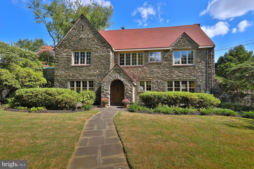 The opportunity you have been waiting for is here. Designed by renowned Architect Arthur T. Smith for Mrs. G Hilliard English, this classic and elegant home is located on the prestigious The Oak Road in East Falls. Homes on this coveted street are rarely available, making this a unique opportunity to live in one of the neighborhood’s most desirable locations. This gracious residence boasts a truly grand vestibule entrance and a striking front door that serves as a true statement piece upon entry. The spacious living areas have high ceilings, abundant natural light, and hardwood floors throughout, offering a blend of modern updates with classic charm. An ultimate gourmet kitchen, featured in Philly Magazine, comes complete with custom cabinetry, high-end appliances, and a large island – perfect for entertaining. The formal dining and living rooms are elegant and timeless and the cozy enclosed porch offers the perfect space to curl up with a book. The beautifully landscaped grounds feature perennial blooms and a private backyard, ideal for outdoor gatherings or serene relaxation. A finished basement with new flooring makes the perfect play space, home gym, or home theater, along with additional basement storage and laundry area. An attached two-car garage, plus additional driveway parking offer plenty of room for you and your guests. The first level includes a flexible office/bedroom and full bathroom just off the kitchen, which can easily be used as a private first floor suite. Upstairs you’ll find four bedrooms: a primary suite with attached dressing room, walk-in closet and custom bathroom; a second suite with elegant fireplace, walk-in closet, full bathroom and balcony overlooking the backyard;  and 2 additional bedrooms flank an additional full bathroom. And you can move without a care because the home boasts new windows (2023), new roof (2018), well maintained mechanical systems and a dual zoned AC system.  Situated in the heart of East Falls, this home offers easy access to scenic walking and biking trails, two SEPTA regional rail lines, shopping, bars and restaurants of Manayunk and Chestnut Hill, all while being minutes away from Center City. The Oak Road is known for its tranquility, mature trees, and stately homes, making this a once-in-a-lifetime chance to live in a location where properties rarely become available.