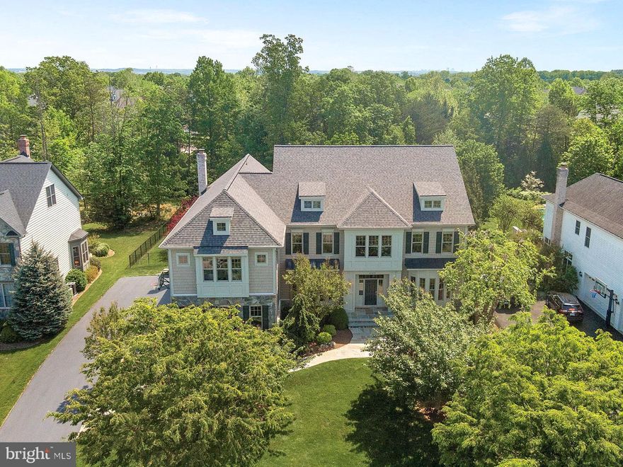OPEN HOUSE CANCELLED!!  UNDER CONTRACT!  Just Listed! Welcome to 21872 Parsells Ridge Ct., a stunning 5-bedroom, 5.5-bath home offering over 6,500 sq. ft. of beautifully finished living space, NEW ROOF (2019) in Ashburn’s highly sought-after Village of Waxpool. Perfectly situated on a quiet cul-de-sac and backing to mature trees, this meticulously maintained Craftmark Oakmont model combines privacy, elegance, and everyday convenience. Zoned for the award-winning Briar Woods High School, Eagle Ridge Middle, and Mill Run Elementary—with both the elementary and middle schools within walking distance!
The home’s outstanding curb appeal is highlighted by a custom flagstone walkway, professional landscaping, dramatic up-lighting and timeless elevation. Inside, soaring ceilings, designer lighting, upgraded trim, wainscoting, and crown molding, and hardwood floors elevate much of the main and upper levels. The elegant foyer features a hardwood spiral staircase, paired with a second staircase off the family room for added functionality.
At the heart of the home is the gourmet kitchen with upgraded appliance package including an oversized refrigerator, 6-burner stove and new dishwasher.  You’ll love the custom backsplash, oversized island, and spacious eat-in area with doors that open to the beautifully landscaped backyard. The adjoining family room features a striking stone fireplace and expansive windows that fill the space with natural light.
The main level also includes a private office with built-ins and French doors, a welcoming living room with a brick-surround fireplace, an elegant dining room perfect for hosting special meals, and a mudroom with built-in bench that leads to the extra-wide 3-car garage with bump-out.
Upstairs, each oversized bedroom includes its own en-suite bath with upgraded cabinetry, ceiling fan and walk-in closet. The luxurious primary suite boasts vaulted ceilings, a spacious sitting room, two large walk-in closets, a dressing area, soaking tub, frameless shower, granite counters and upgraded cabinetry. Plus, the laundry room is on the bedroom level for added convenience.
The finished lower level offers a generous recreation space with updated LVP flooring, a gas fireplace with stone surround, custom paint, a fully equipped home theater with seating and components, a legal 5th bedroom, full bath, large storage rooms, and walk-up access to the beautiful backyard. There’s even a rough-in ready for your wet bar! 
Sitting on a .53-acre flat, fully fenced lot, the home’s outdoor space is a private retreat with lush landscaping, an elegant patio, and plenty of room to entertain, relax, or play. Additional upgrades include a new roof (2019), energy-efficient windows, brand new carpet, and fresh paint throughout. Three gas fireplaces (family room convertible to wood-burning) add warmth and charm throughout the home.
Ideally located near major commuter routes, shopping, dining, medical facilities, INOVA Loudoun Hospital, Dulles Airport, Dulles Greenway, Routes 28 and 7, and just 2 miles to the Silver Line Metro. Where luxury meets livability—this home has it all and is move-in ready! MUST SEE!