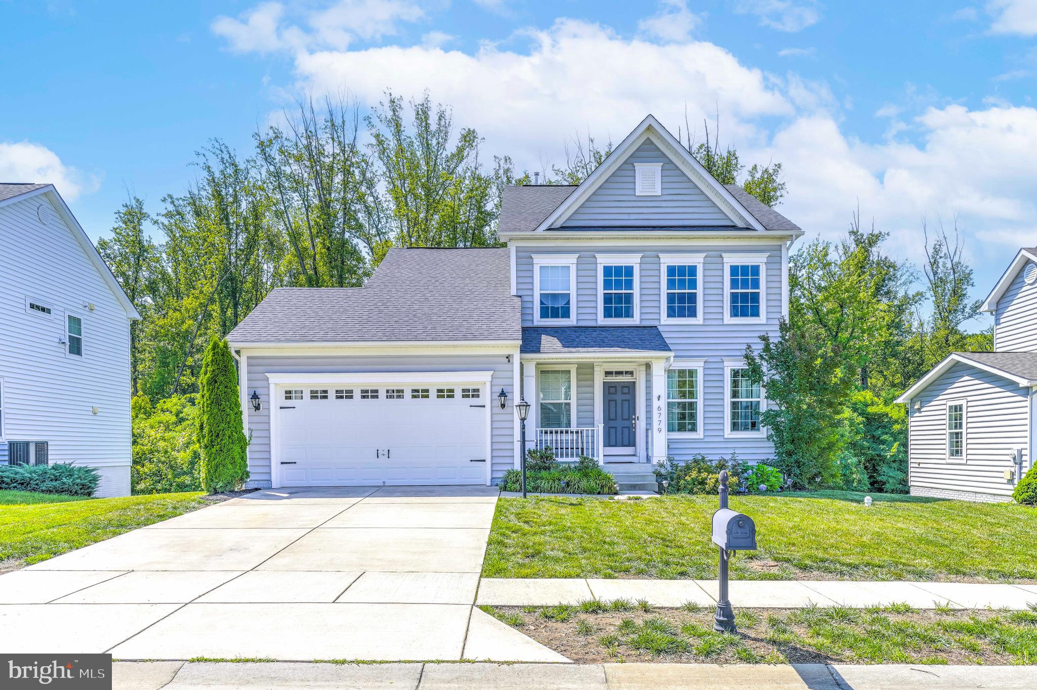 Beautiful Colonial Home in Sought-After Marshall Grove Estates! This stunning 3-bedroom, 3.5-bath colonial offers modern living with classic charm. Enjoy the engineered hardwood flowing throughout the main level, an open-concept layout, and soaring cathedral ceilings in the living room that flood the space with natural light. The spacious kitchen features an extensive island perfect for entertaining, and opens to a bright sunroom—ideal for casual dining or morning coffee. A versatile flex room on the main level can serve as a home office or formal sitting area. Upstairs, you'll find a convenient laundry room and generously sized bedrooms. The expansive, fully open basement includes a walk-out to a private backyard that backs to serene woods—perfect for relaxing or hosting gatherings. Located in a community with great amenities including a dog park, playground, and open green spaces. Don't miss your chance to own this gorgeous home.