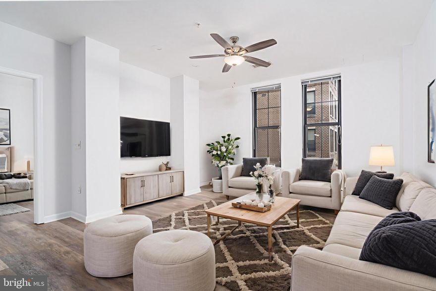 Prime Location in the Heart of Falls Church City! Welcome to The Spectrum, a highly sought-after address offering the ultimate in convenience, walkability, and modern living. This stylish 2-bedroom, 2-bathroom condo is perfectly situated in the vibrant City Center—just steps to shops, restaurants, the library, farmers market, and the W&OD Trail. This 4th floor unit is quiet, close to the elevator and has great natural light.
Inside, you'll find an open-concept layout featuring durable luxury vinyl plank flooring (2019) and a sleek, a fully updated kitchen (2019) complete with a center island, stainless steel appliances, and ample cabinet space. Recessed lighting in the main living area (2025) with dimmers on both the accent wall and above the kitchen island adds ambiance and functionality.

Thoughtfully designed for privacy, this split-bedroom floorplan places each bedroom suite on opposite sides of the unit. The spacious primary suite boasts a walk-in closet and a luxurious en-suite bathroom with a soaking tub and separate shower. The second bedroom also includes its own walk-in closet, a full bathroom, and access to a private balcony—perfect for morning coffee or evening unwinding.

Additional features include a full-size, in-unit washer and dryer, two reserved garage parking spaces (conveniently located across from one another), and two oversized storage units.

Pet-friendly building (max 2 pets, no weight restrictions) with impressive amenities:
✔ Rooftop deck (currently being renovated with new furniture, pergolas & Wi-Fi)
✔ Grassy picnic area
✔ Business center & conference room
✔ Party room & lounge
✔ Concierge service & elevator
✔ Immediate move-in
✔ Exercise Room on the same floor as unit!

Commuters will appreciate quick access to Routes 7, 29, and 50, as well as I-66 and I-495—just a short drive to Washington D.C. and The Pentagon. Conveniently located between East and West Falls Church Metro! VA Financing approved! Meridian High School, a top-rated and newly built facility, is conveniently located nearby. This is urban living at its finest—schedule your tour today!