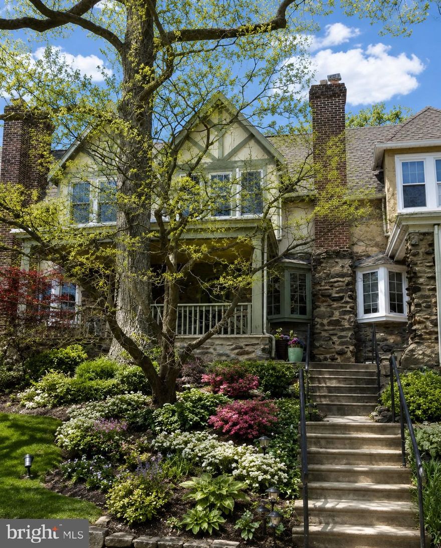 7525 Germantown Avenue — a beautifully refreshed 1920s Tudor-style row home where timeless architectural charm meets sophisticated modern living in the heart of Chestnut Hill and West Mount Airy. Perched gracefully above Germantown Avenue and overlooking the picturesque, park-like grounds across the street, this stunning 3-bedroom residence offers an exceptional blend of historic character, thoughtful updates, and an unbeatable Philadelphia location.

From the moment you arrive, the elevated setting, classic Tudor façade, and inviting covered front porch create a warm and elegant first impression. Enjoy peaceful mornings overlooking mature green space, or unwind in the evening with coffee, wine, or conversation on the brand-new rear deck — the perfect outdoor extension of the home for entertaining and dining al fresco.

Inside, the home has been freshly painted and thoughtfully updated throughout, creating a bright, airy atmosphere while preserving the craftsmanship and charm of the original era. Rich original hardwood oak floors with mahogany inlay flow through the living room, formal dining room, and upstairs bedrooms, adding warmth and sophistication to every space.

The spacious sun-filled living room features a beautiful bow window and graceful arched entryways that lead into an elegant formal dining room complete with original glass-paneled doors, classic chair rail detailing, oversized baseboard moldings, and charming architectural alcoves rarely found in today’s homes.

The updated kitchen blends modern finishes with timeless style and features designer appliances, granite countertops, crown molding, beadboard accents, and ample room for casual dining. Just beyond the kitchen, step directly onto the newly added rear deck — ideal for hosting guests, grilling outdoors, or simply enjoying the tranquility of the surrounding neighborhood.

Upstairs, the sun-drenched primary bedroom offers hardwood flooring and classic period details, while two additional spacious bedrooms provide flexibility for guests, home office space, or growing families. The hall bathroom features a tiled shower, separate soaking tub, mirrored medicine cabinet, and updated finishes. Additional hallway storage, fresh carpeting, and linen closets add both comfort and functionality.

The unfinished basement provides exceptional storage space, washer and dryer, utility sink, outside access, and a private one-car garage with interior access — a rare convenience in this sought-after neighborhood.

Additional major improvements include a newly installed heater and a recently sealed and coated roof with a transferable 5-year warranty for added peace of mind.

Located just moments from the vibrant shops, cafés, restaurants, and boutiques of both Chestnut Hill and West Mount Airy, this home places you in one of Philadelphia’s most desirable and walkable neighborhoods. Enjoy nearby parks, playgrounds, the scenic trails of the Wissahickon Valley Park, and effortless commuting options with close proximity to regional rail, SEPTA bus lines, and Center City Philadelphia.

This is a rare opportunity to own a home that seamlessly combines historic elegance, modern comfort, outdoor living, and an exceptional location.

Schedule your private showing today and experience the charm of 7525 Germantown Avenue for yourself.