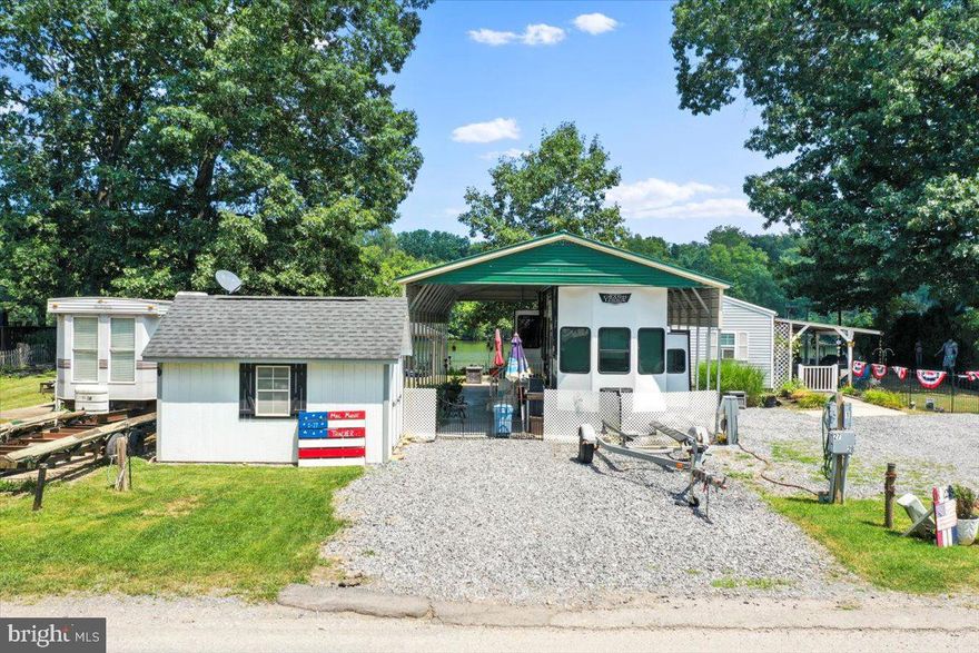 Make your riverfront dreams come true with Lot 1-27 in River Bend Park! This riverfront lot comes fully equipped with a luxury 2022 RV, private dock, pontoon boat, pavilion, shed, golf cart, outdoor kitchen, furniture, and lush landscaping—everything you need for the ultimate summer escape. Located in the gated, seasonal River Bend Park community (open April 1–November 1), ownership includes access to amenities like bath houses, laundry facilities, a camp store, sports courts, miniature golf, a restaurant, and more. Annual dues of $1,775 cover electricity, water, trash, pump-outs, and community amenities. Visitors must check in at the guard shack and be accompanied by an agent or lot owner. Just bring your swimsuit—this one’s ready to enjoy!