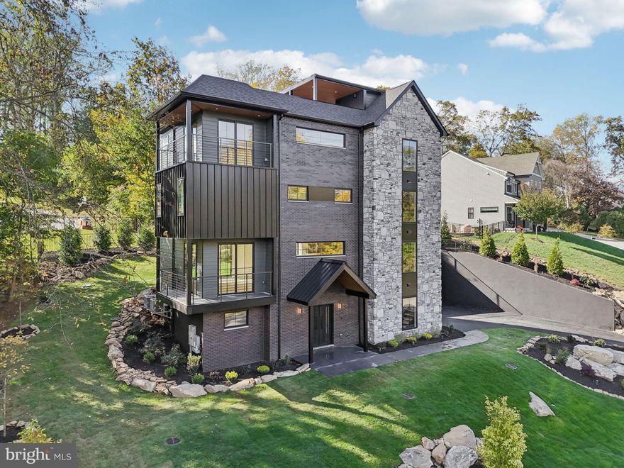 Introducing 12 Langton Lane- a fully custom, 4 bed, 3.5 bath new construction home designed and built by Giappo Design+Build. Known for their sharp eye on blending aesthetics with smart functionality, this magnificent property is tucked away on a quiet cul-de-sac street in the sought after Runnymeade Farms community in Edgmont/Newtown Square. This distinctive 4 story single family home offers gorgeous tree top views from multiple wrap-around corner balconies and what could very well be the only true rooftop deck in the immediate area! Nothing was overlooked throughout the building process and the attention to detail shows in every material that was selected. Enter the home through the black iron double doors where you are greeted by a sleek temperature controlled wine room with wet bar and tasting area. The recreation space to the left is perfect for a home gym or private office- the enormous closet lends to added storage or could be used for an indoor sauna. Easy access to the utility room and a 2-car garage can be found on this level. Ascend up the floating staircase to an unbelievable living area with wide plank engineered white oak floors laid in a mesmerizing herringbone pattern. Experience refined luxury in the breathtaking European-style kitchen designed by Giappo and supplied by Omega Kitchens & Decor. Featuring custom wood grain cabinetry, soft-closing hardware, and glass-front display cabinets with integrated lighting. The expansive 7x9ft single slab Trevi quartz island serves as the focal point, enhanced by LED toe-kick and under-cabinet lighting while the premium finishes include matte black fixtures, professional stainless-steel Thermador appliances, and a clean, open layout that seamlessly blends functionality and beauty. The attached walk-in pantry provides matching cabinets and quartz countertop with bookmarked backsplash offering plenty of additional storage perfect for all your entertaining needs. Off of this level, there is a corner wrap-around balcony and a 10ft double slider to the rear yard lending to more indoor/outdoor living. This space is completed with a powder room and coat closet. Follow to the next floor with an oversized laundry room; an ensuite bedroom with its own private bathroom with curbless shower; a second spacious bedroom that shares a hall bathroom with double sink vanity and tub/shower combo, and a bonus space that could be used as a children’s playroom or office. The primary suite encompasses the majority of the 4th level. Here you will find a stunning black soap stone wet bar with beverage fridge; an office/bonus space with 2 closets (could technically be another bedroom); the primary bedroom with a private wrap around corner balcony and a luxurious primary bathroom with a spa-like shower and a double sink vanity that connects to a massive walk-in closet. The final set of stairs does not disappoint and takes you to the rooftop deck that overlooks the tranquil woods and the covered porch is perfect to place a TV or fireplace. This space is an entertainer's dream! The exterior offers tons of lighting, professional landscaping, and a tiered, rear yard oasis. Located in the highly sought after Rose Tree Media School District, this home is close to the shopping and dining of downtown Media and Ellis Preserve while being close to all major roadways for an easy commute. Call today for more information or to schedule an appointment; this one-of-a-kind property is not to be missed!