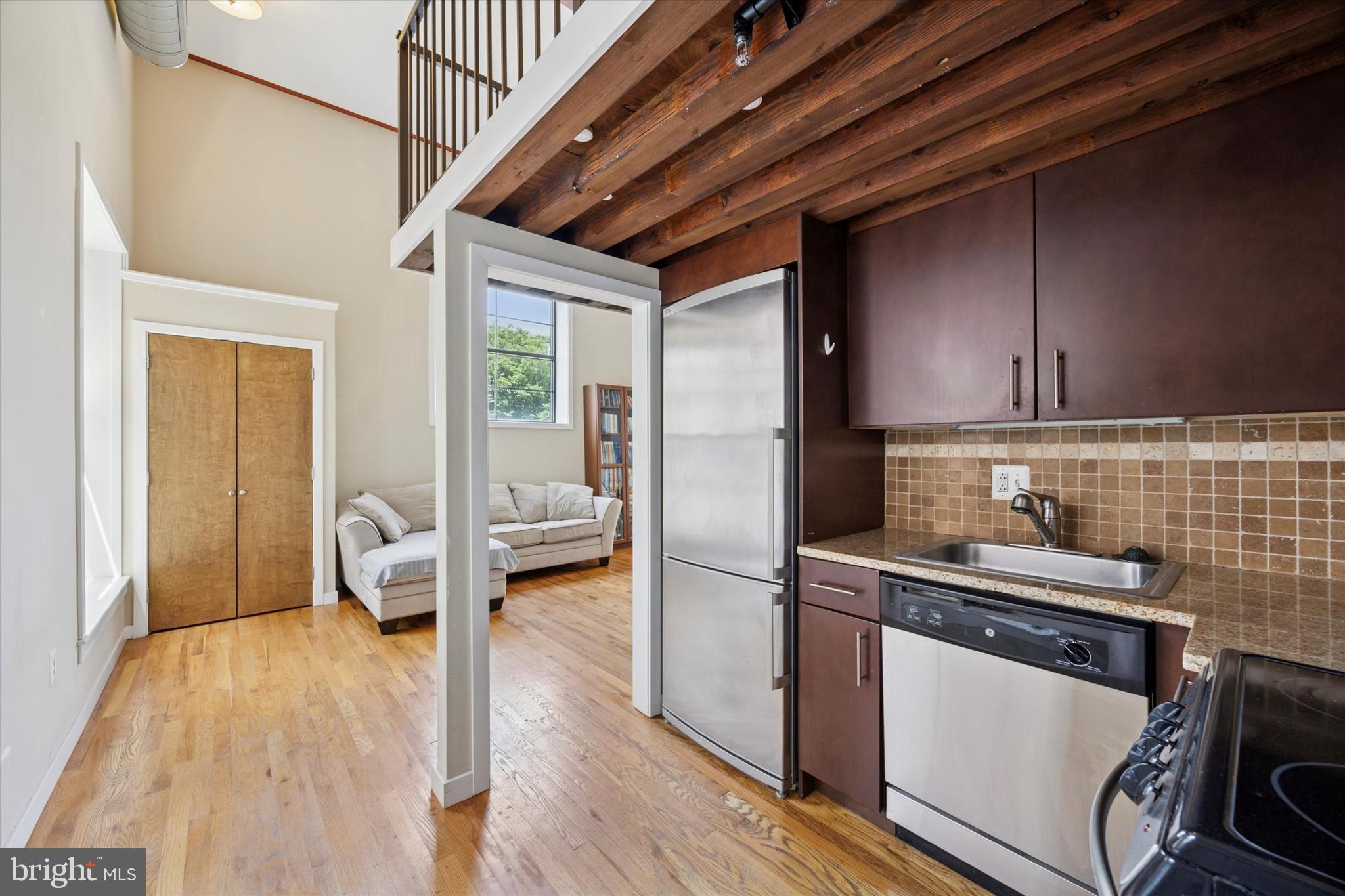 Welcome to Unit 204 at Hawthorne Lofts, an exceptional bi-level condominium offering modern living within a beautifully converted schoolhouse. This unit boasts soaring 14-foot ceilings and expansive windows that invite abundant natural light, highlighting the hardwood floors and top-of-the-line finishes throughout. Enjoy one of the largest bathrooms in the building, providing a luxurious and spacious retreat.
Residents of Hawthorne Lofts benefit from an impressive array of amenities, including a fully equipped fitness center, a serene yoga room, and a relaxation area featuring a sauna and steam room. The expansive first-floor lounge offers a communal space with a TV and pool table. One of the best features is access to the largest roof deck in the city, providing spectacular 360-degree views of the Philadelphia skyline. Complimentary on-site, front-loading washers and dryers are also available for residents.
Situated in the vibrant Hawthorne / Bella Vista neighborhood, this home offers unparalleled convenience. It's just two blocks from the Broad Street Line, ensuring easy access to public transportation, and a short walk to major attractions like the Kimmel Center and City Hall. Everyday essentials are readily available with Acme and Whole Foods nearby, the Italian Market just down the street, and an array of excellent dining options all within close proximity. This pet-friendly building, with a dedicated building manager, combines historic charm with contemporary comforts, making it an ideal urban sanctuary.